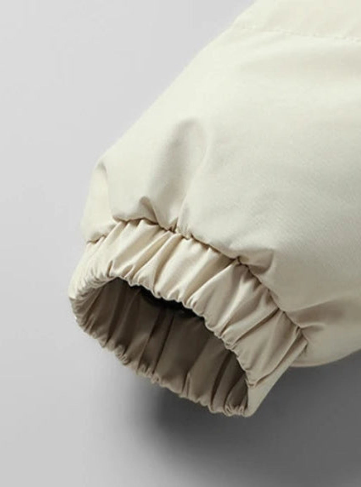 Close-up of a beige pillow with a plain background