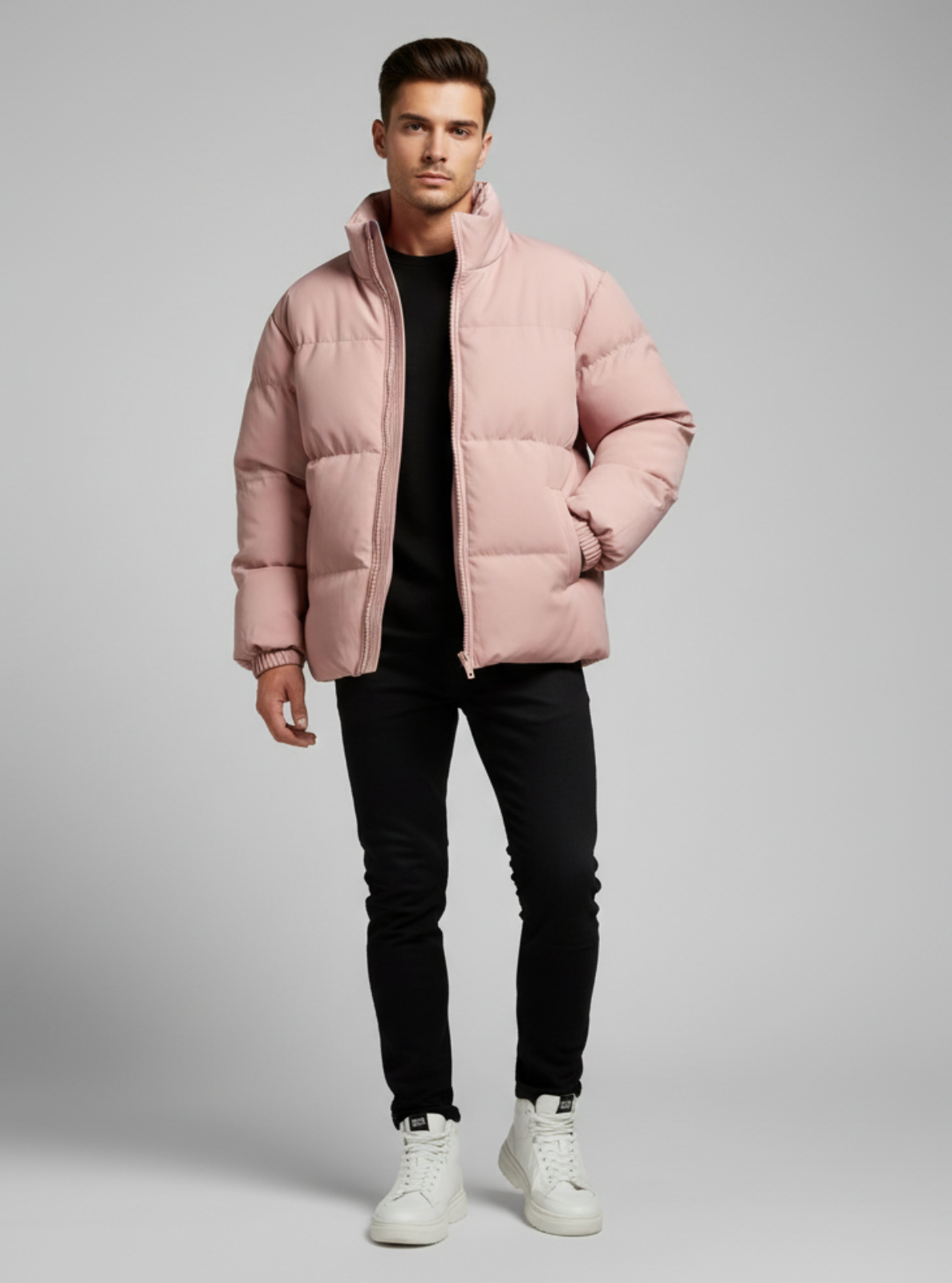 Man wearing a pink puffer jacket on a gray background