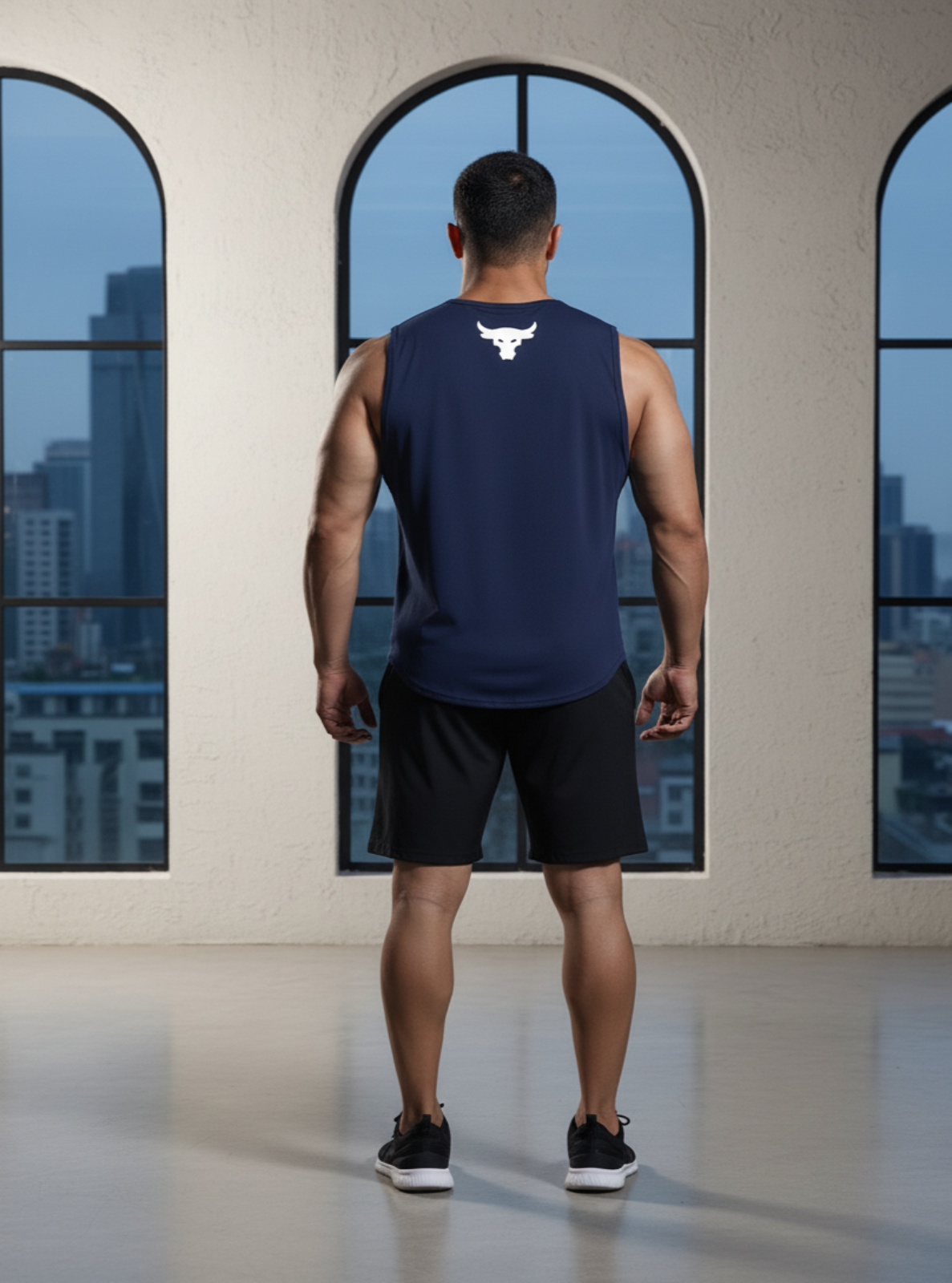Man in navy blue tank top and shorts standing