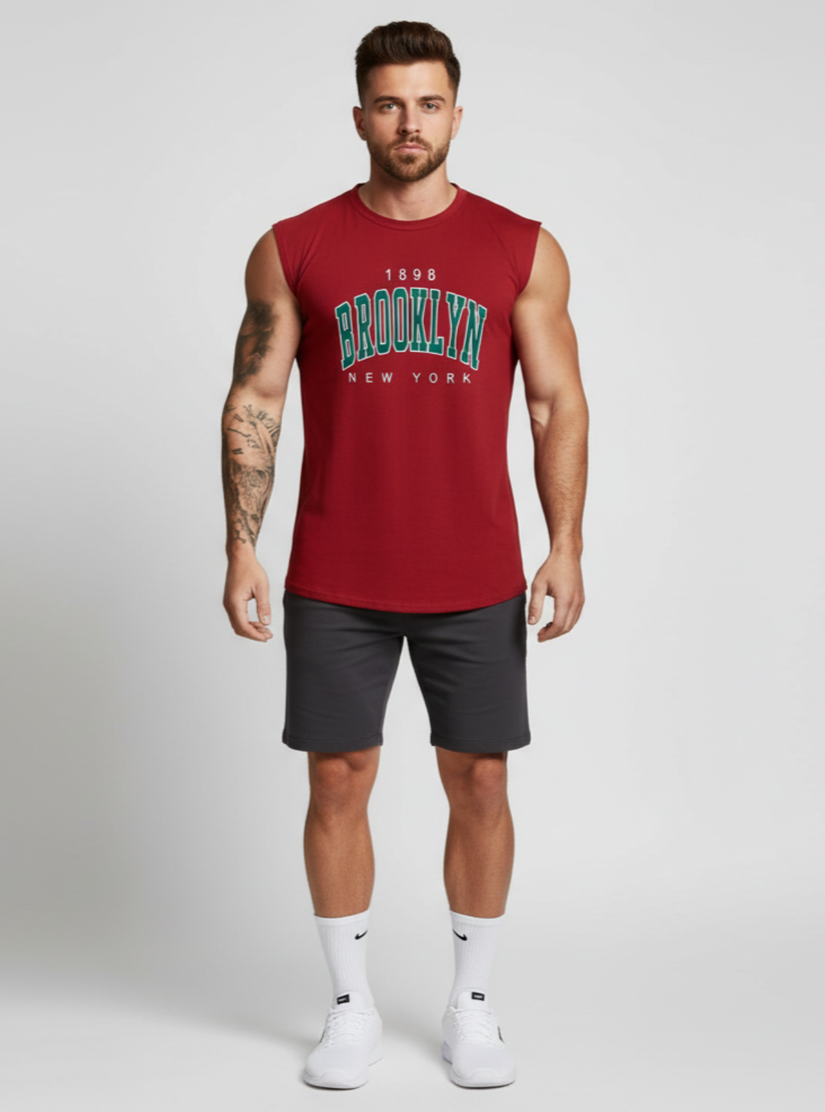 Man wearing a red sleeveless shirt with 'Brooklyn New York' text on a white background