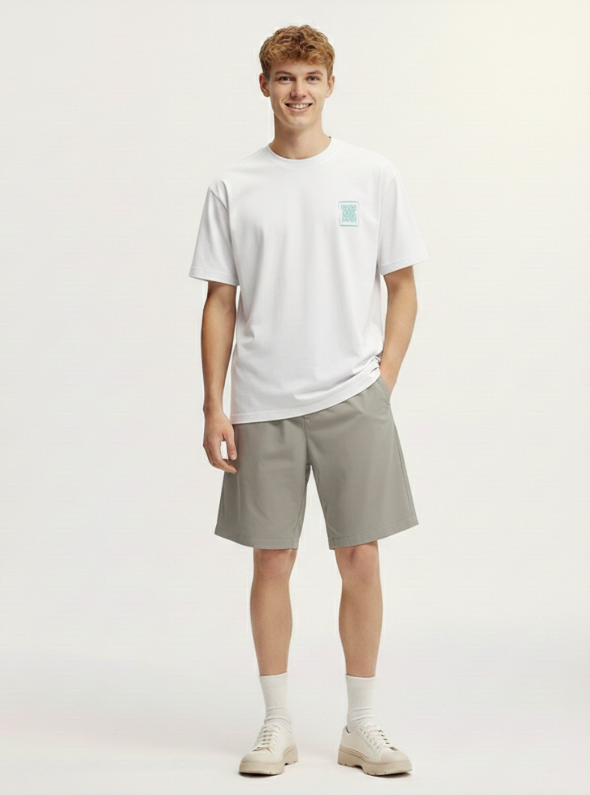 Person wearing a white t-shirt and gray shorts on a plain background