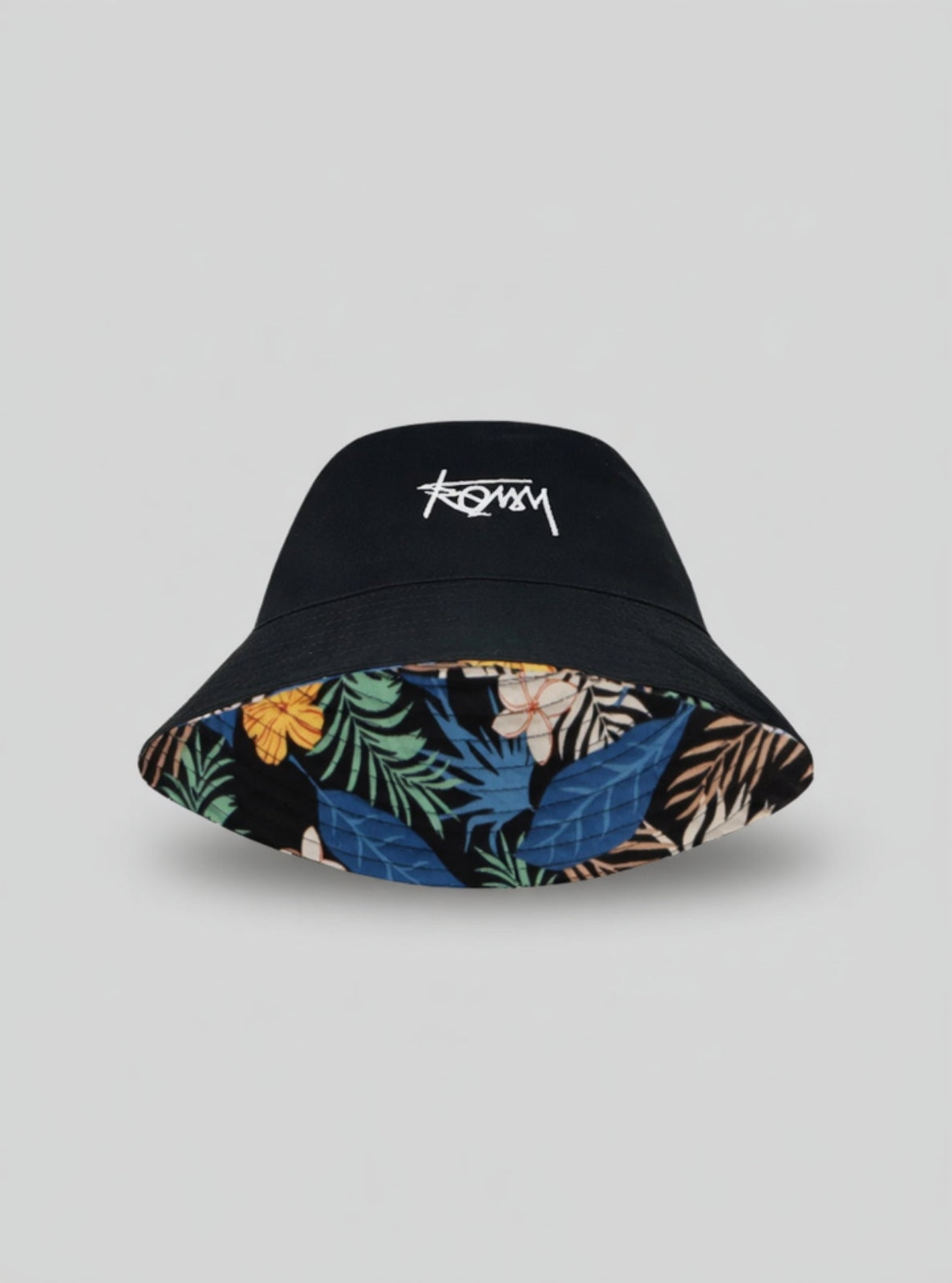 Black bucket hat with tropical leaf pattern inside on a light gray background