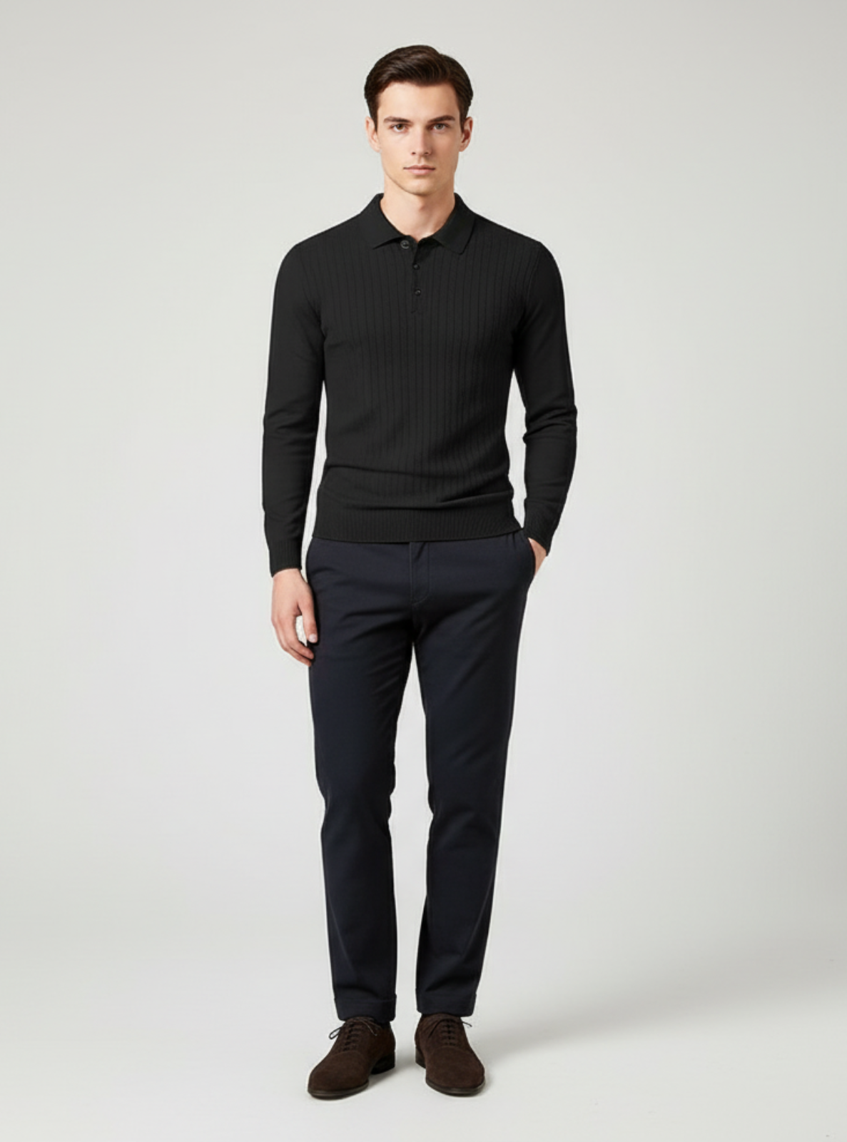 Man wearing a black sweater and dark pants on a white background
