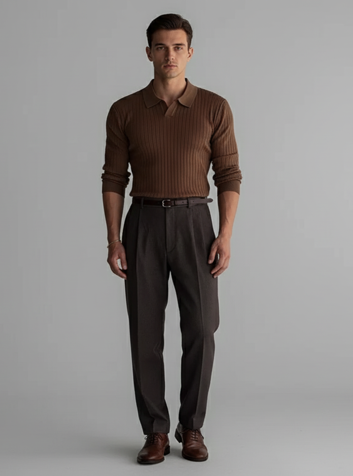 Man wearing a brown ribbed sweater and matching pants on a gray background