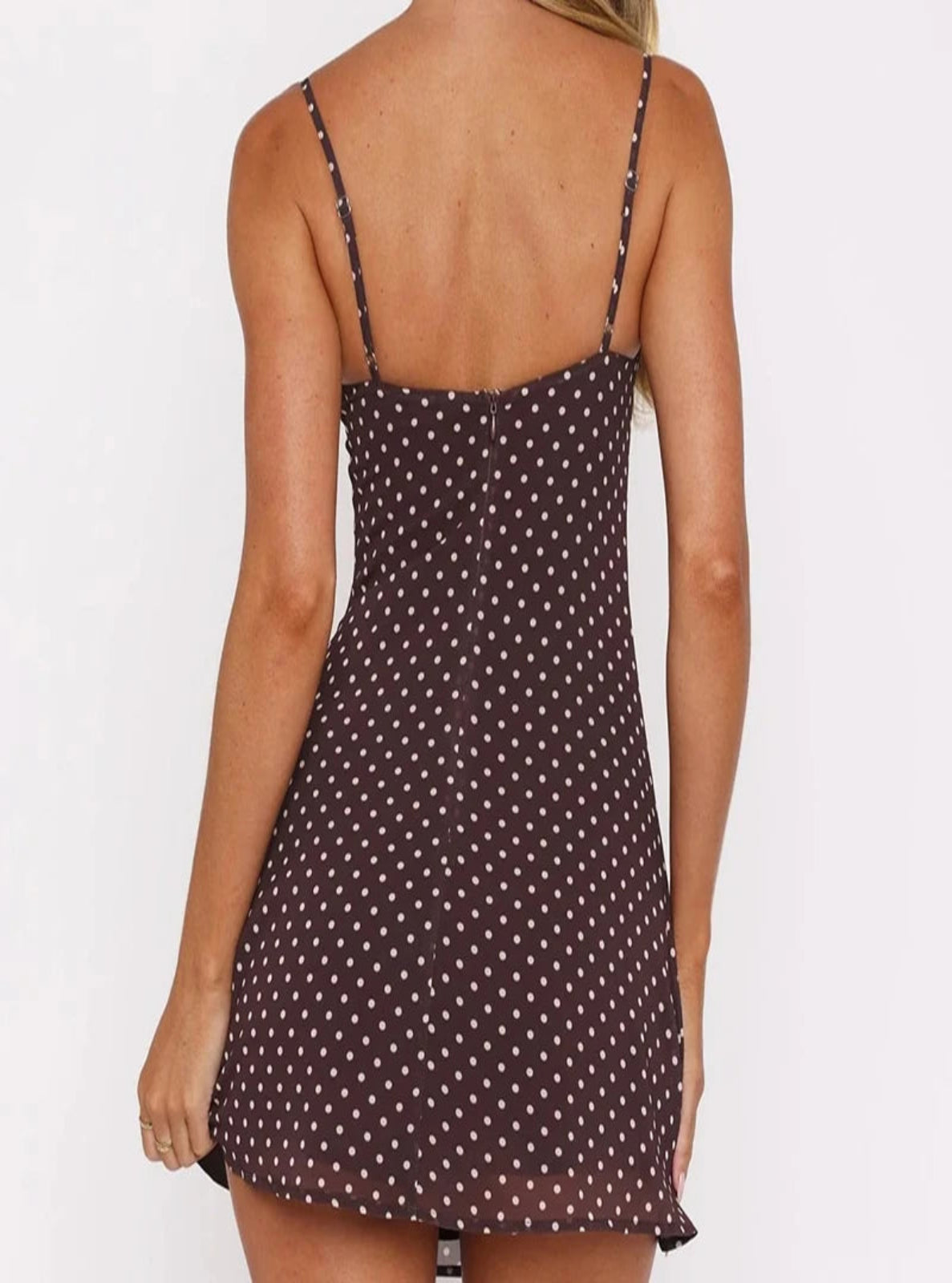 Woman wearing a polka dot dress on a white background