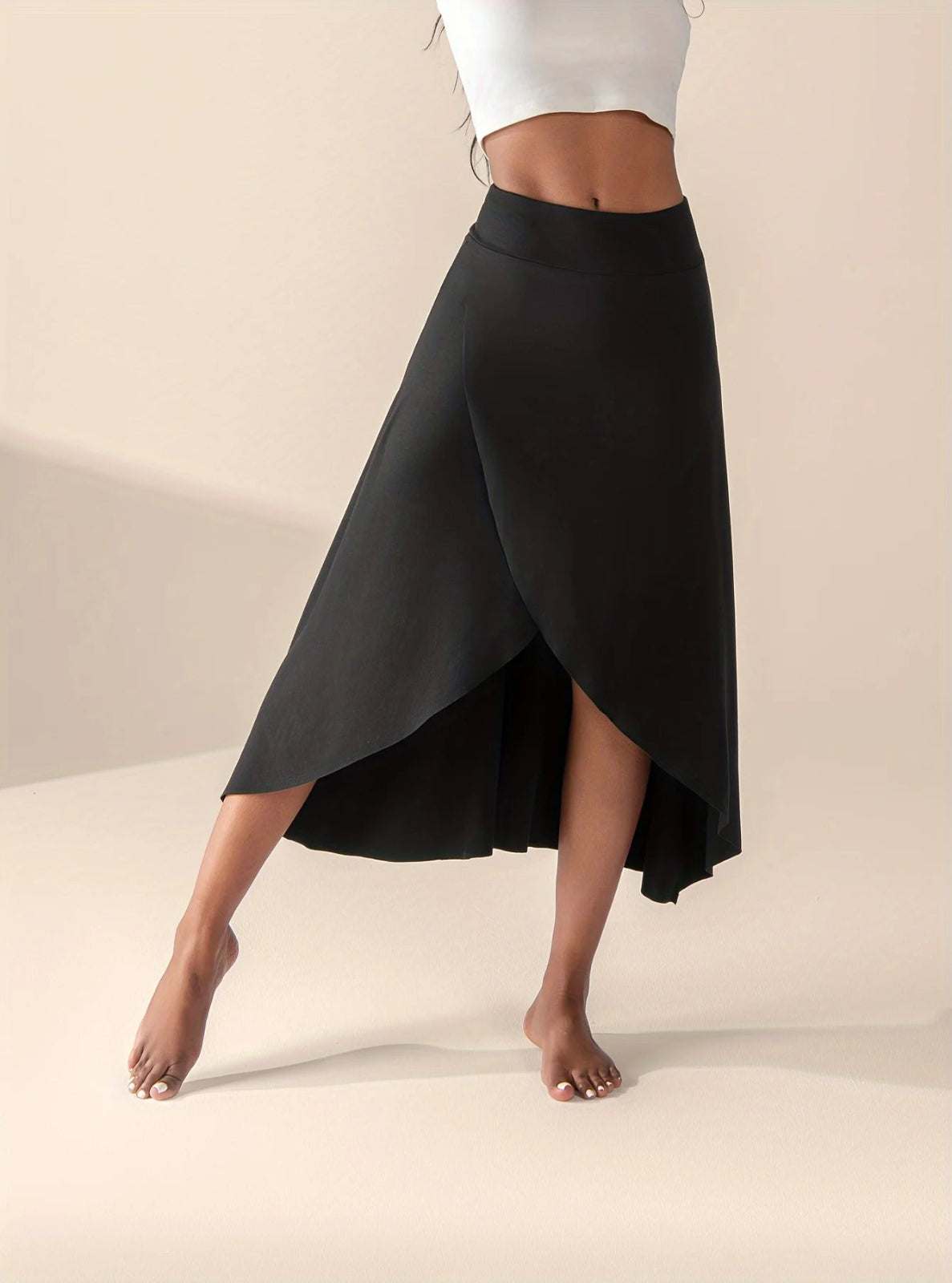 Person wearing a black skirt on a beige background