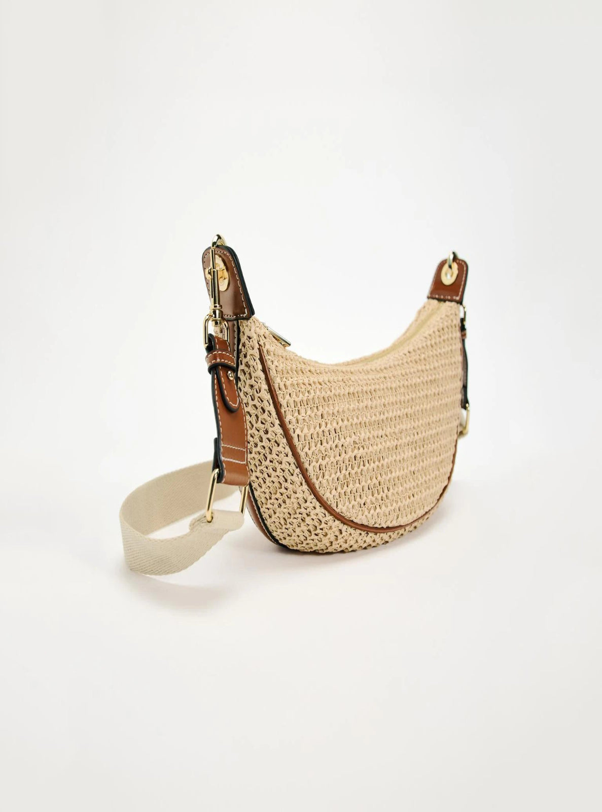 Woven handbag with leather accents on a white background