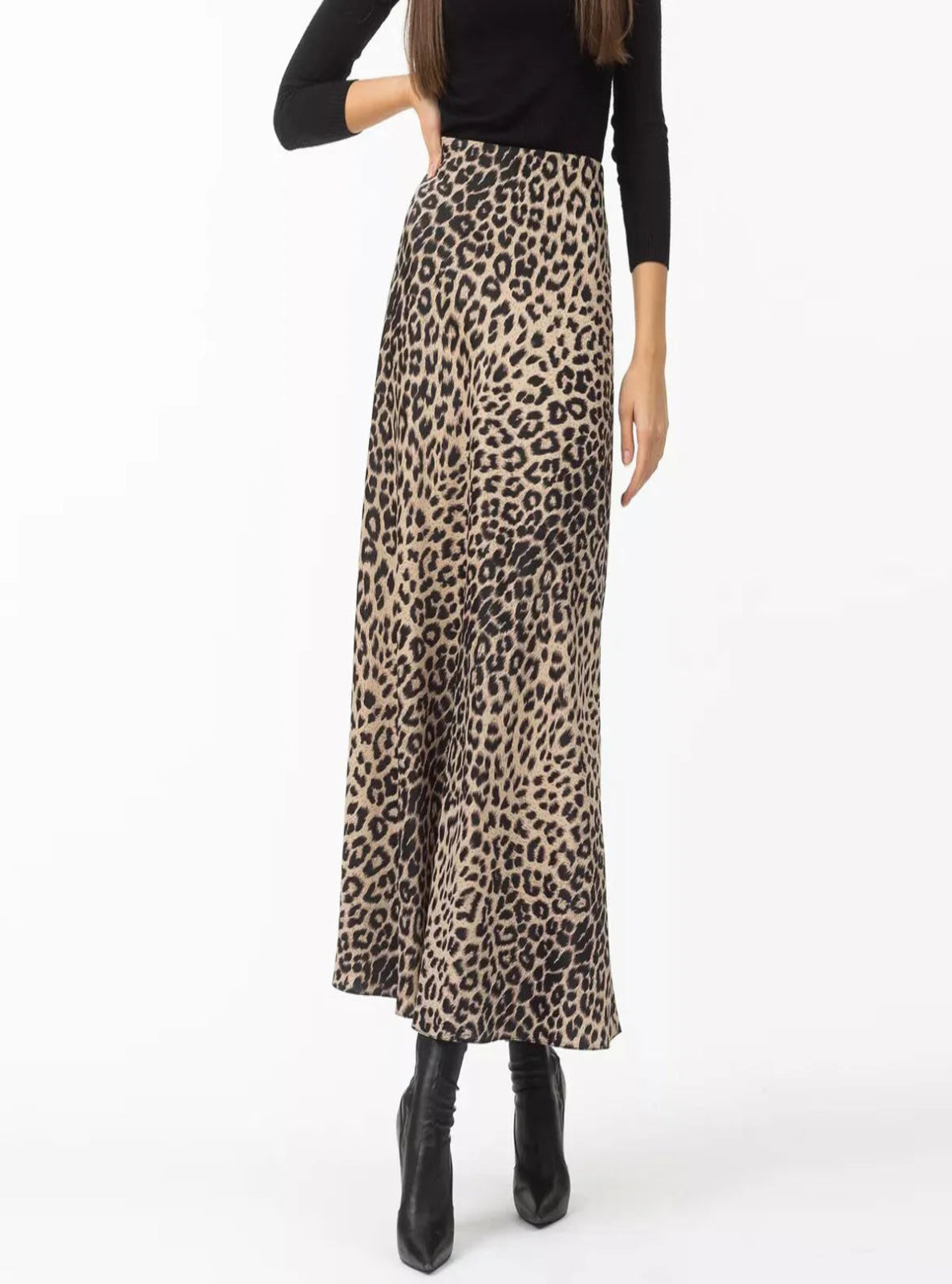 Person wearing a leopard print skirt on a white background