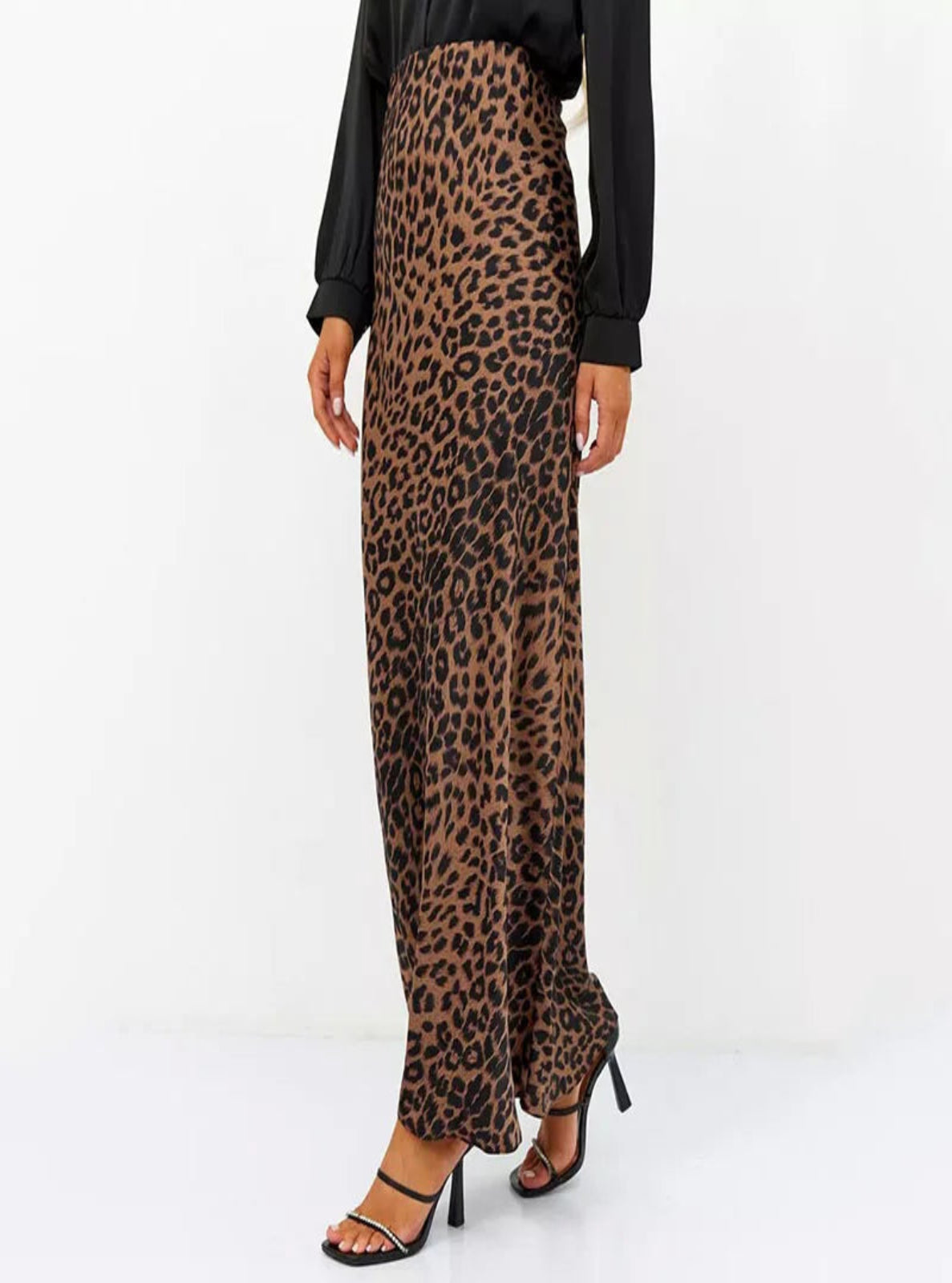 Leopard print pants worn by a person on a white background