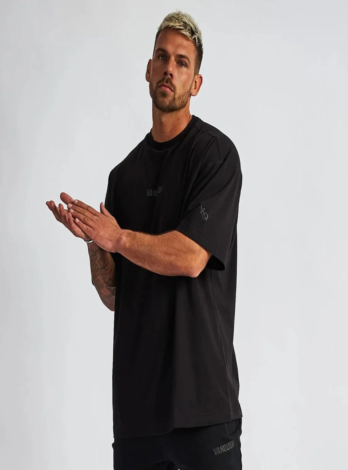 Man wearing a black t-shirt against a plain background