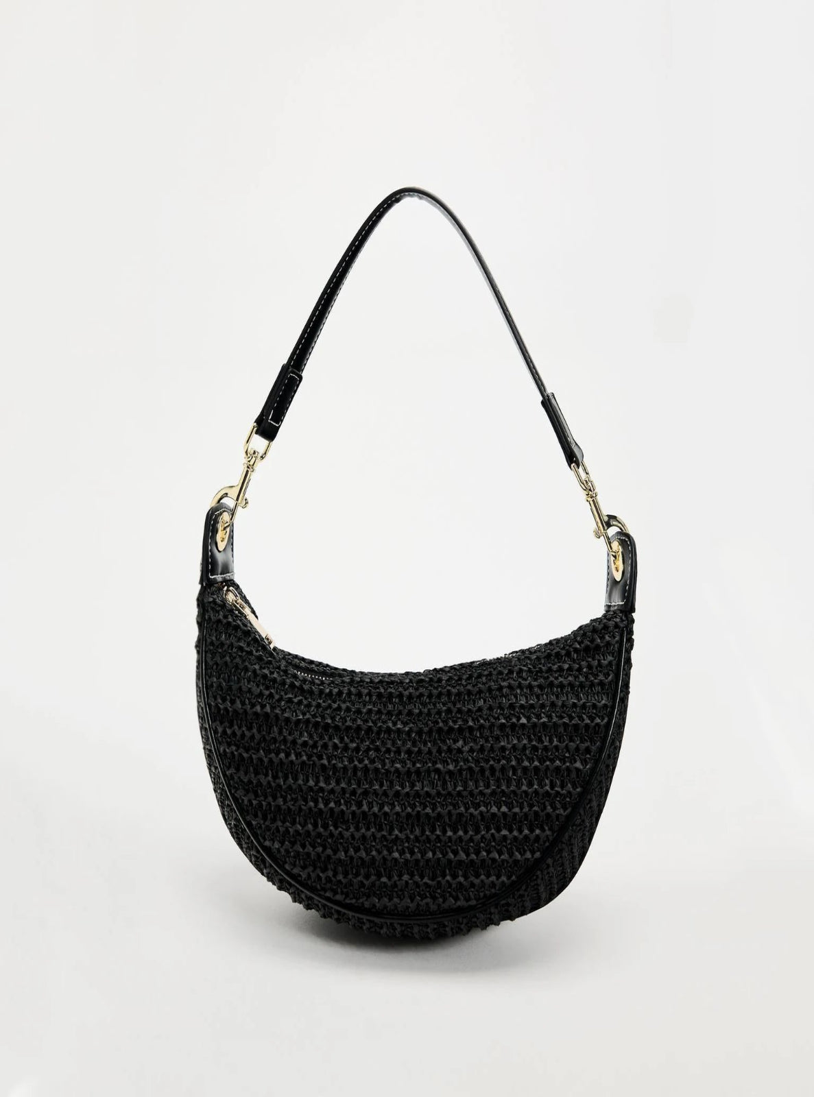 Black woven handbag with a strap on a white background
