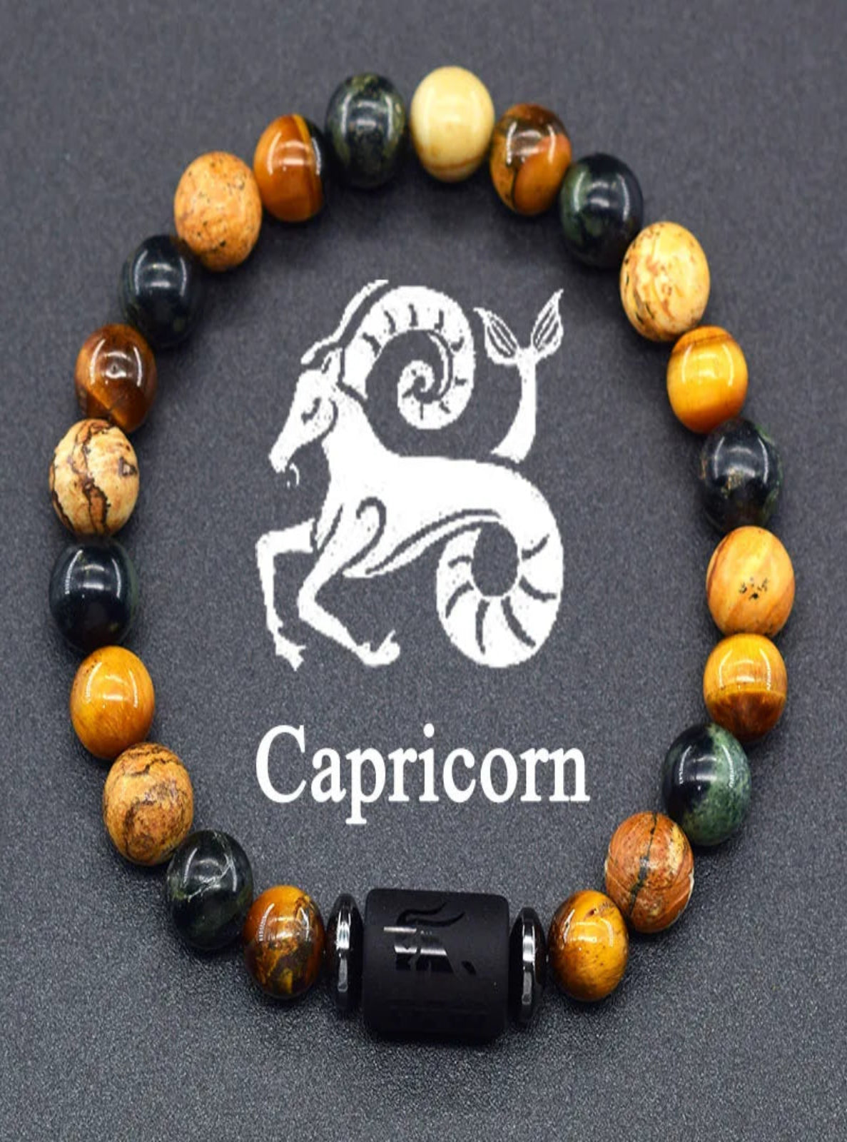Beaded bracelet with Capricorn symbol on a dark background