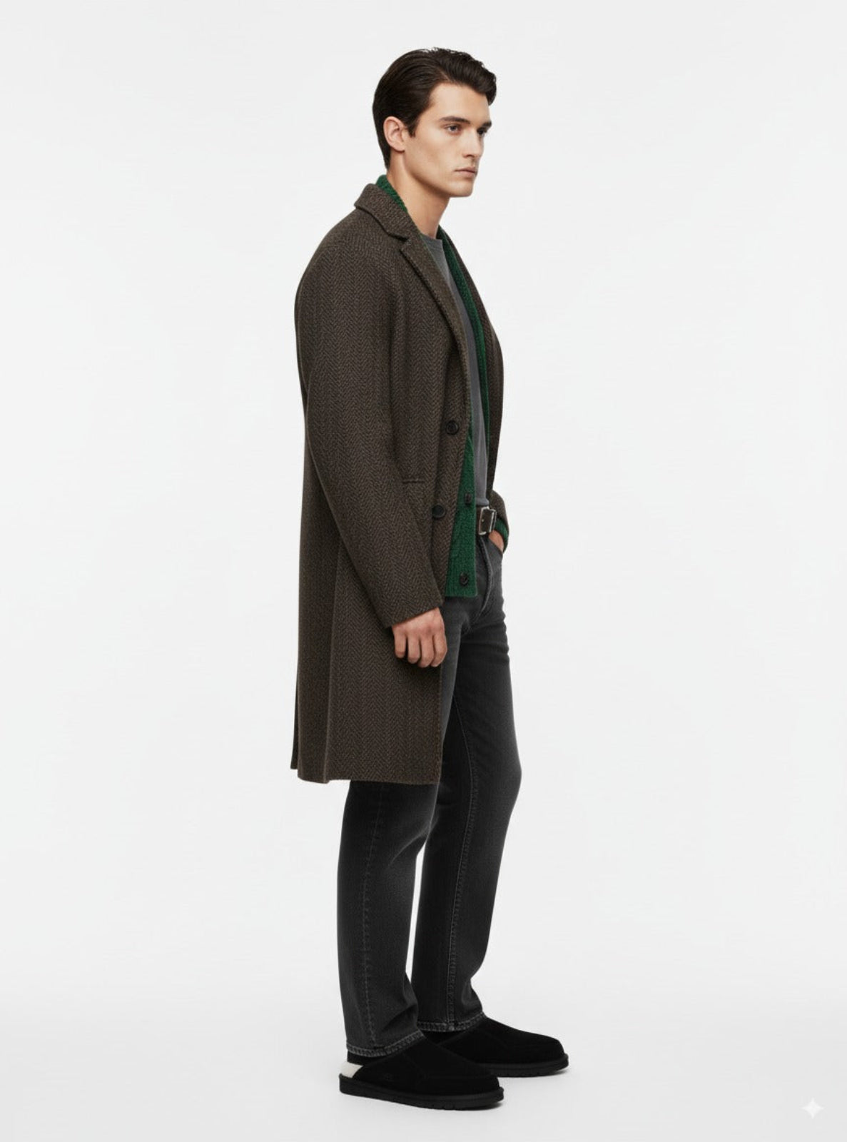 Man wearing a brown overcoat and dark pants on a white background