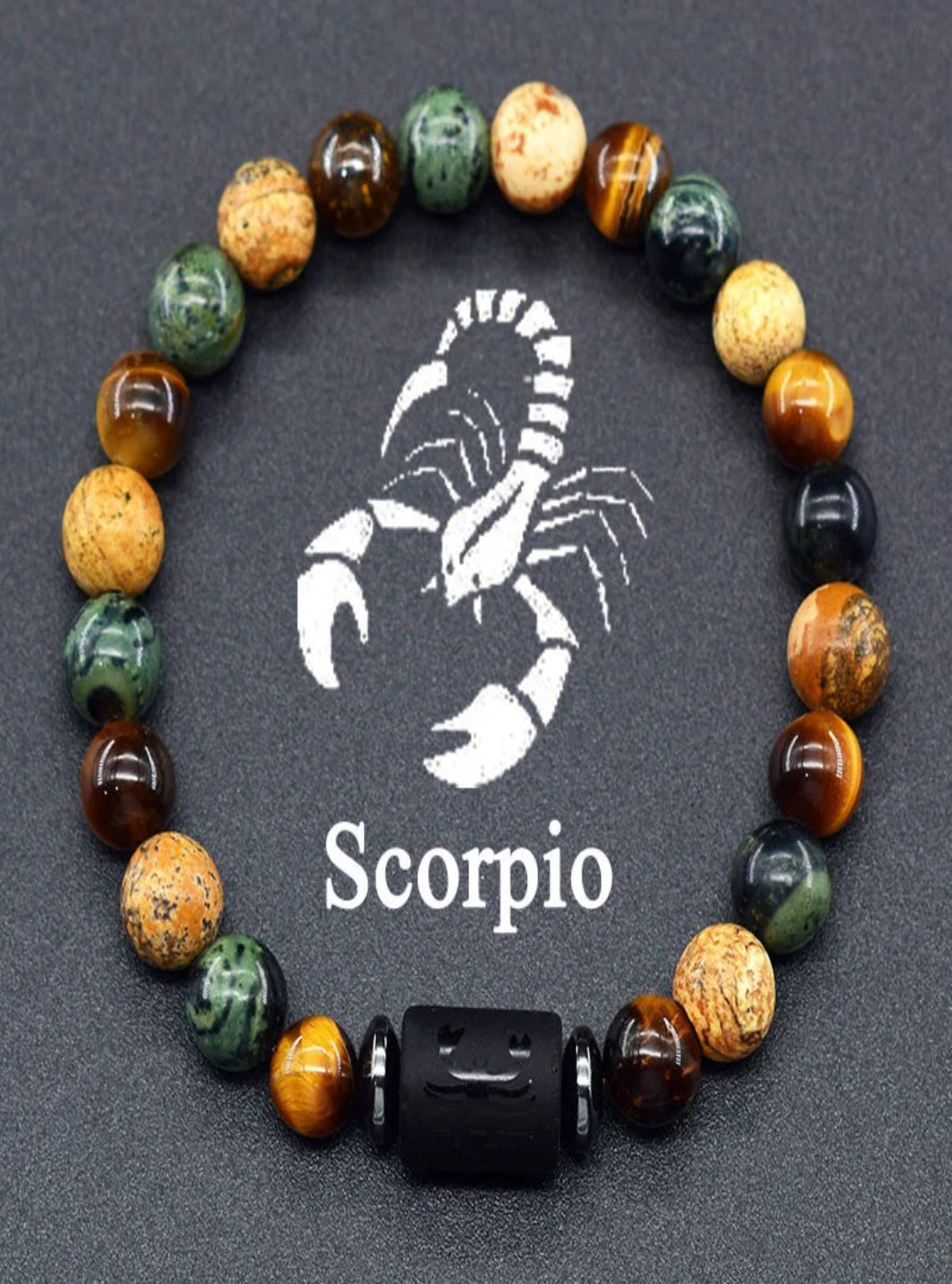 Multicolored beaded bracelet with a Scorpio zodiac symbol on a dark background