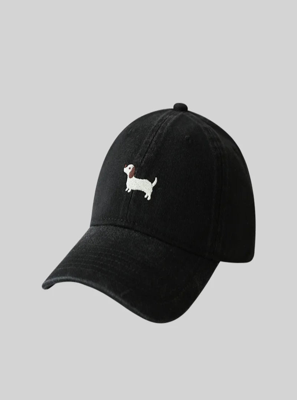 Black cap with a white dog illustration on a gray background