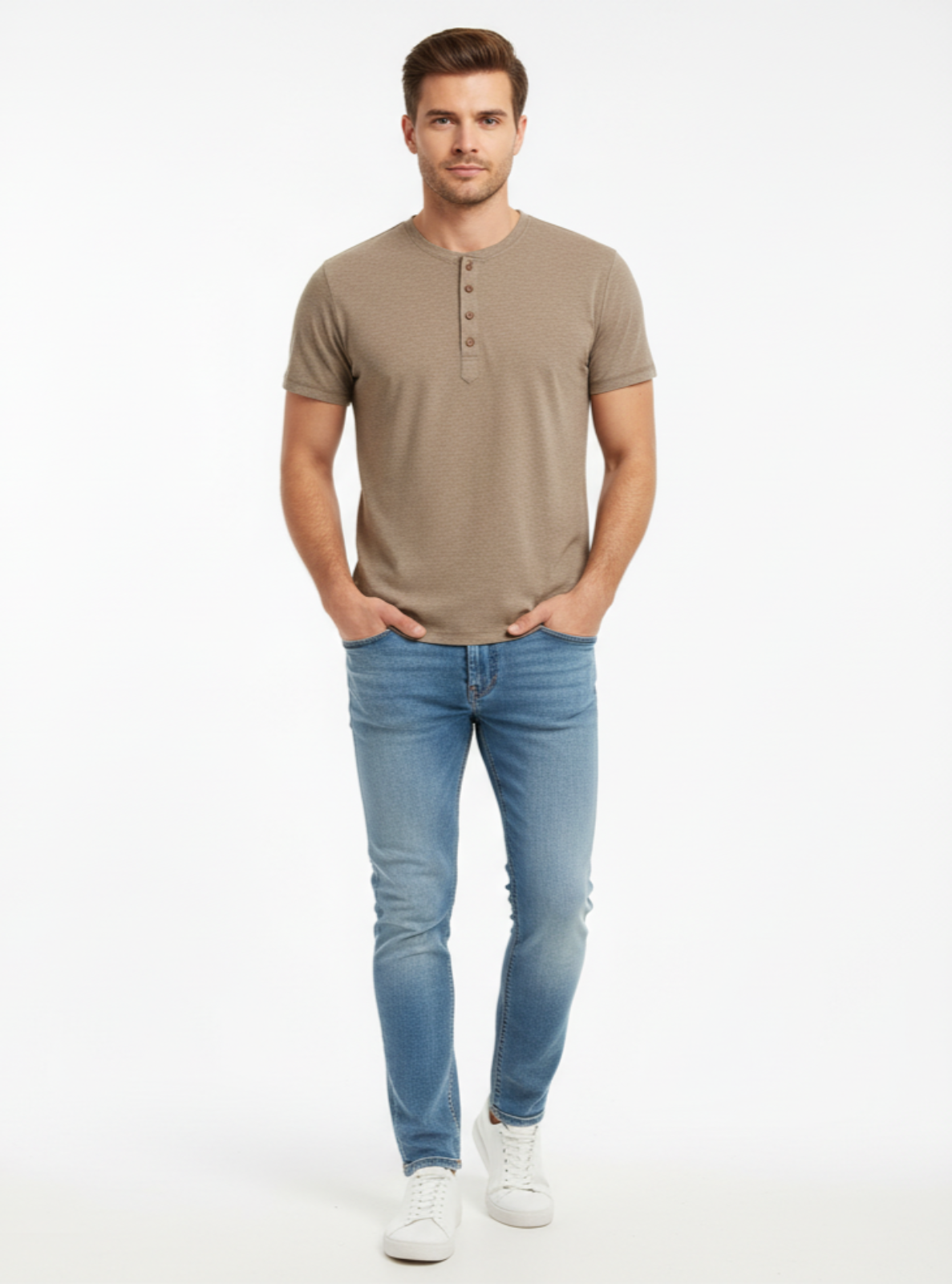Man wearing a brown henley shirt and blue jeans on a white background