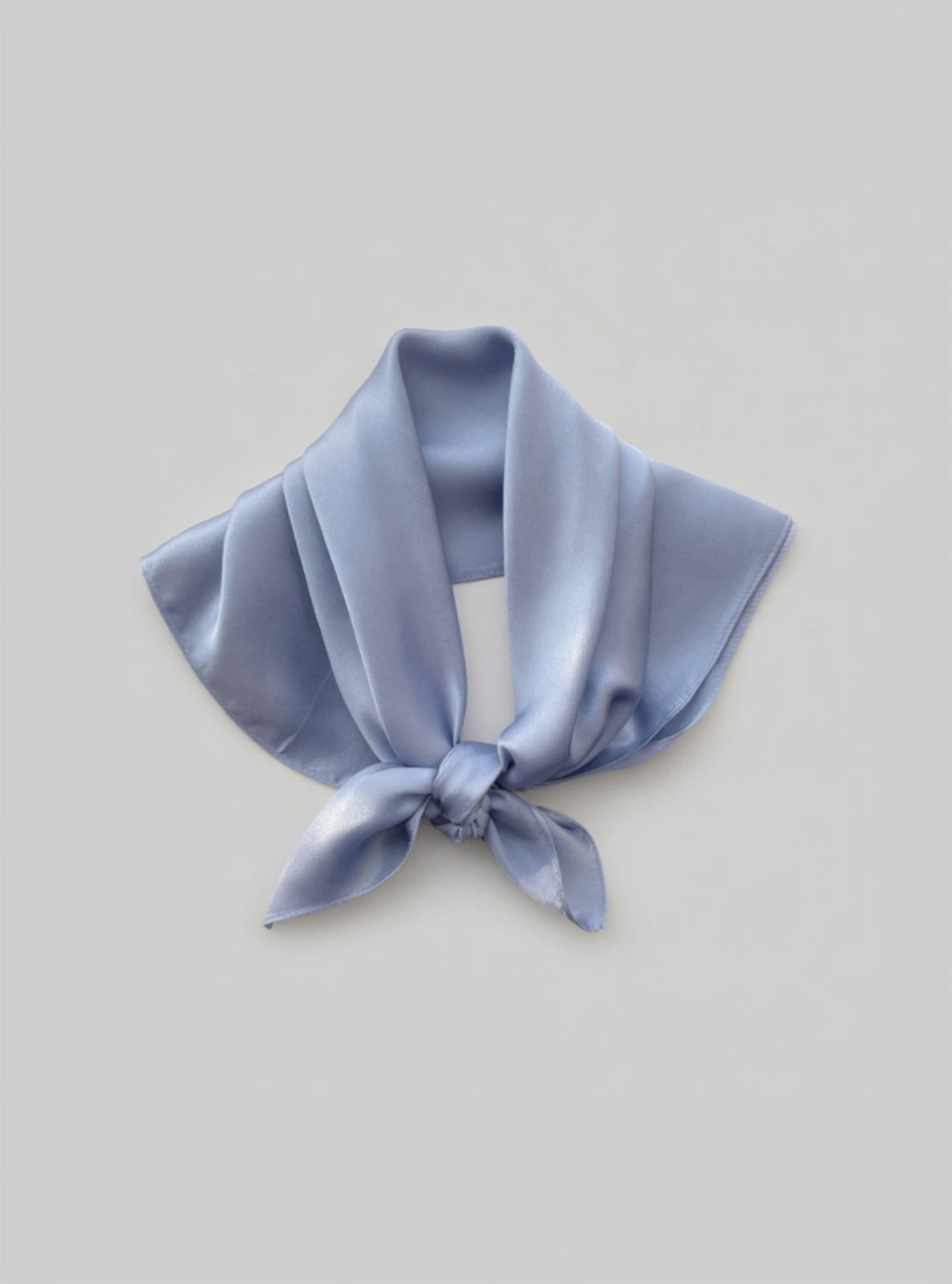 Light blue satin scarf tied neatly on a light gray background