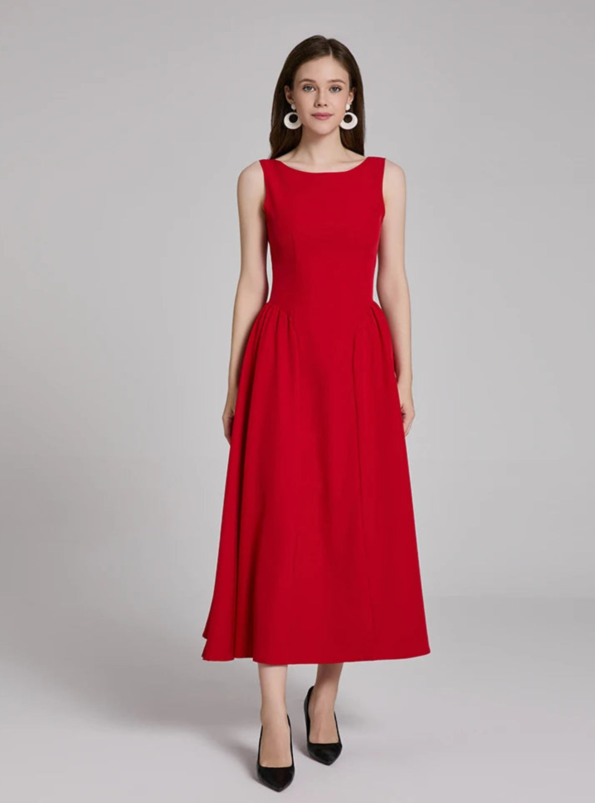 Woman wearing a red dress on a gray background