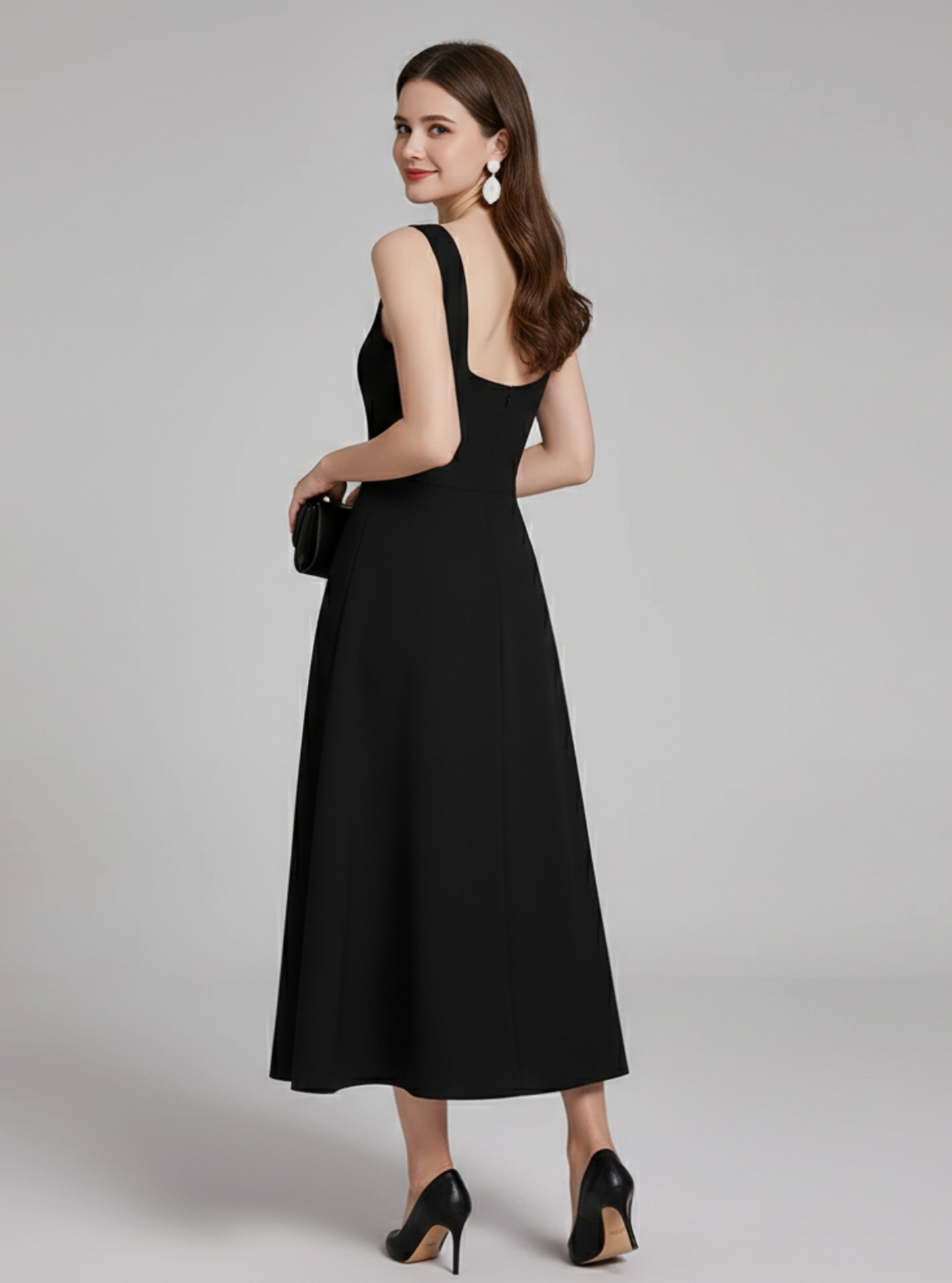 Woman wearing a black dress on a gray background