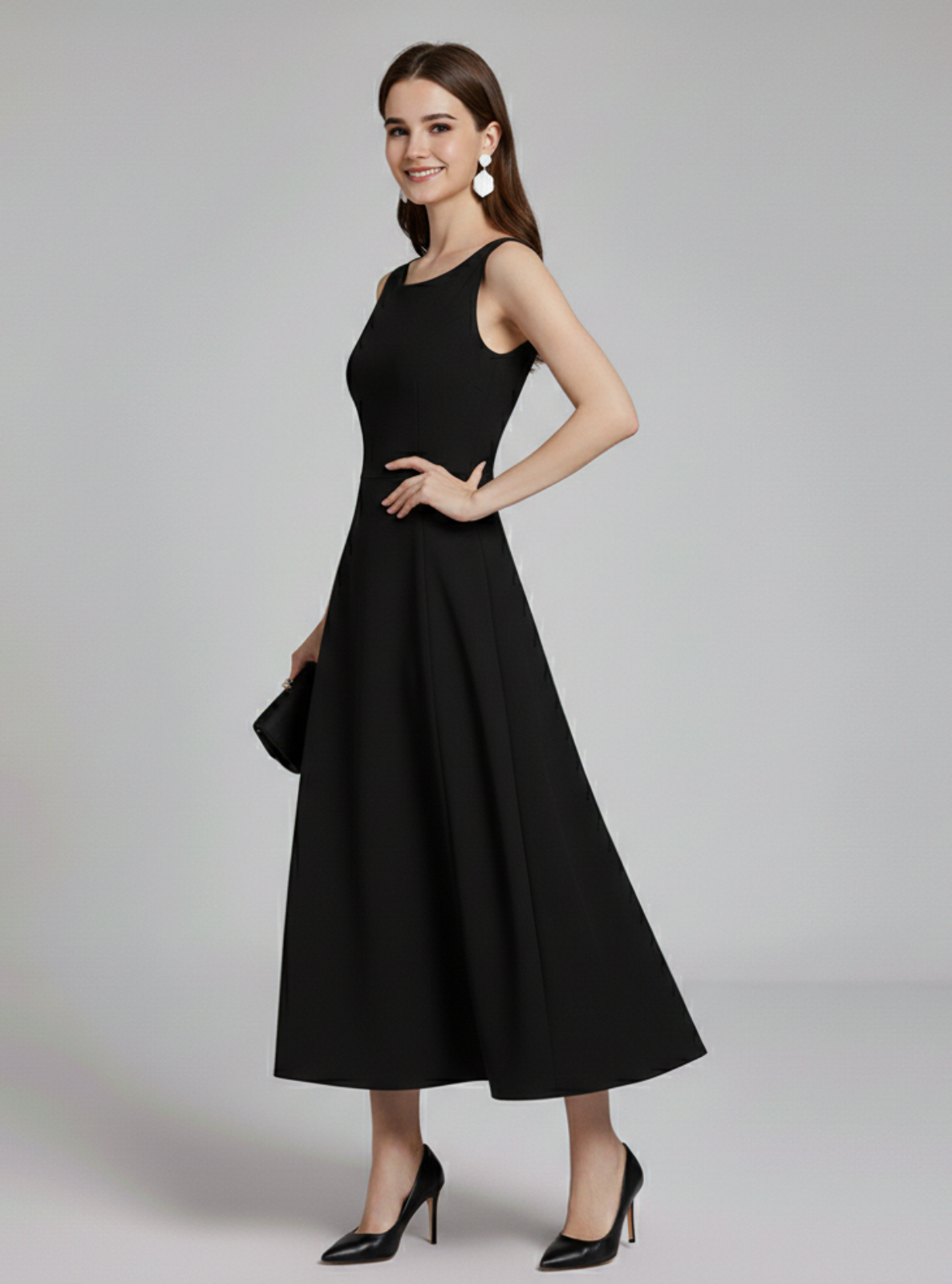 Woman wearing a black dress on a gray background