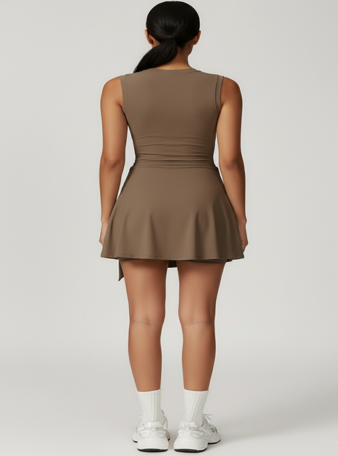 Woman wearing a brown dress on a white background