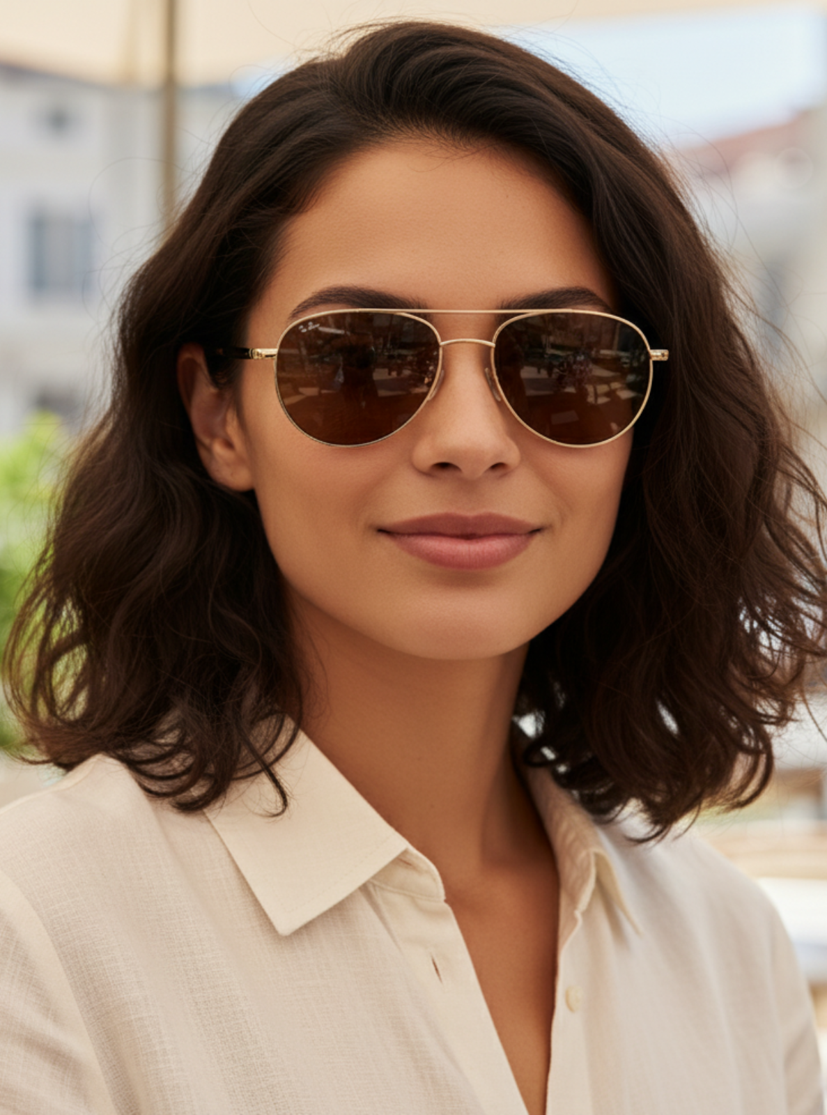 Woman wearing sunglasses with a blurred outdoor background