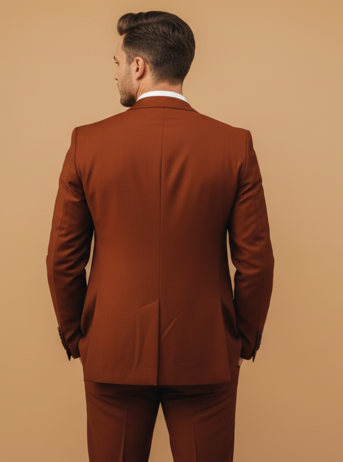 Man wearing a brown suit against a beige background