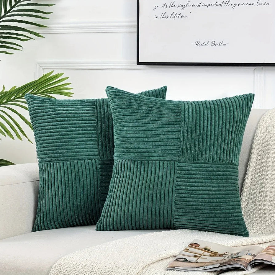 Three green textured pillows on a sofa with a plant and framed quote in the background.
