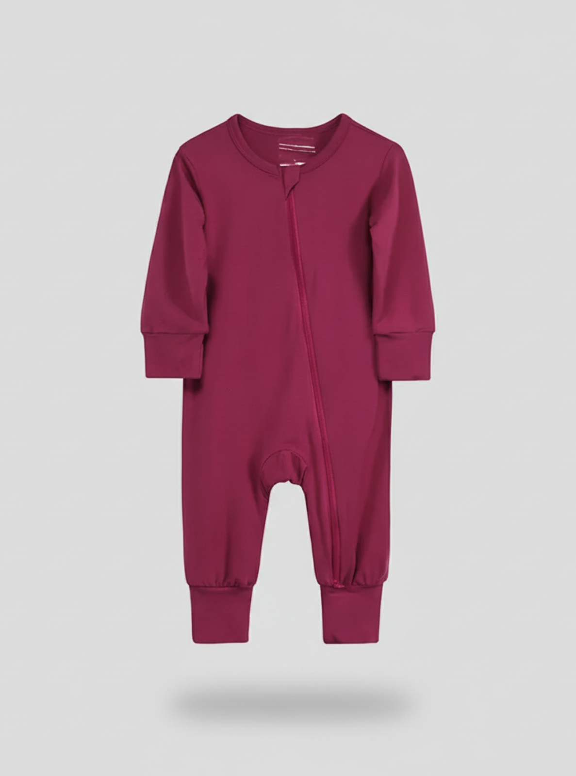 Purple baby onesie on a light gray background