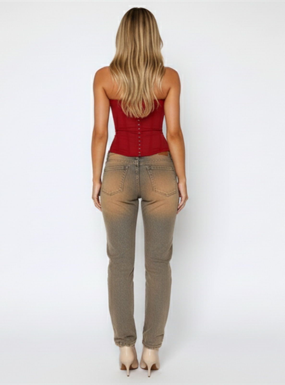 Woman wearing a red top and beige pants on a white background