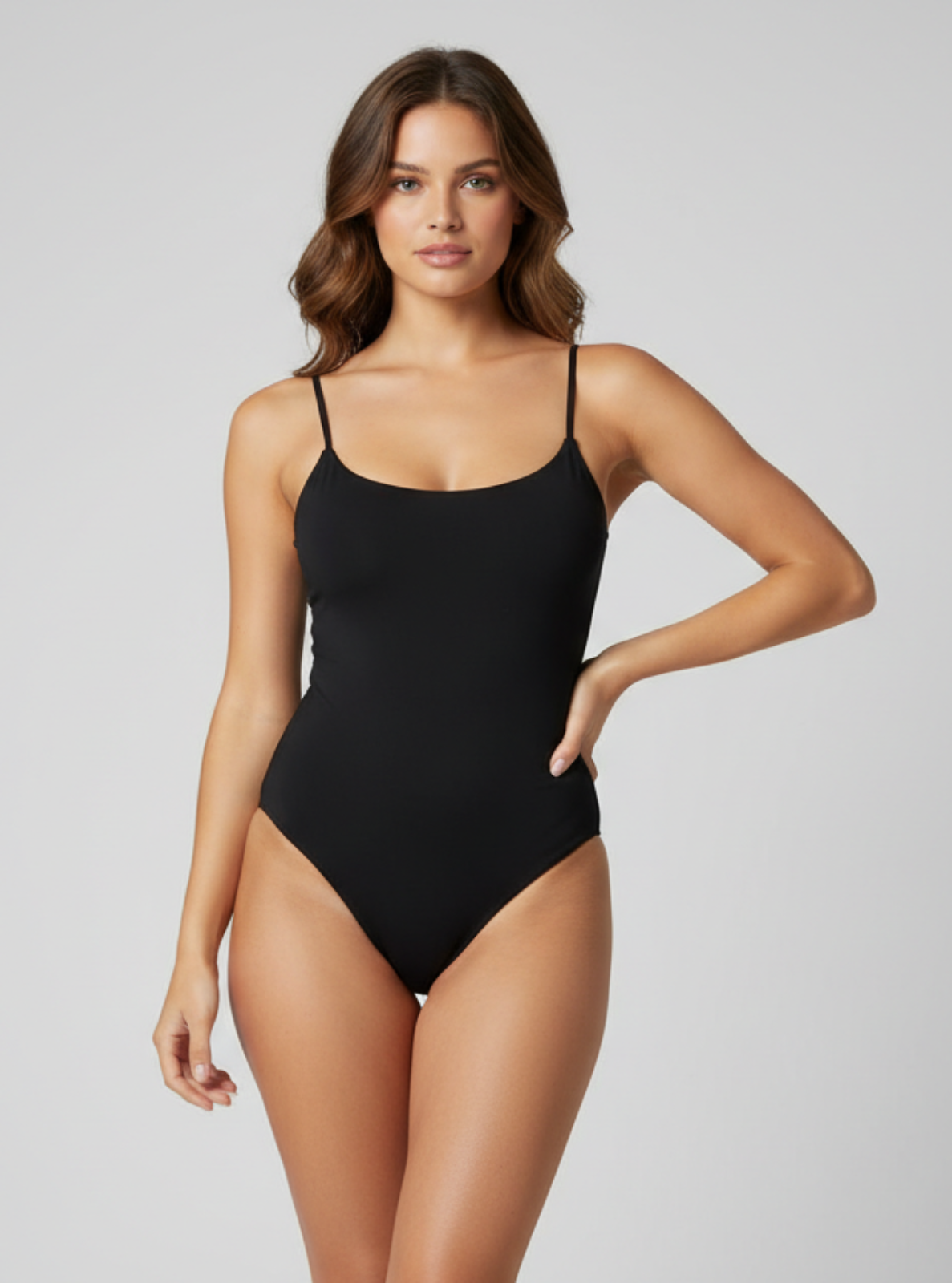 Woman wearing a black swimsuit on a gray background