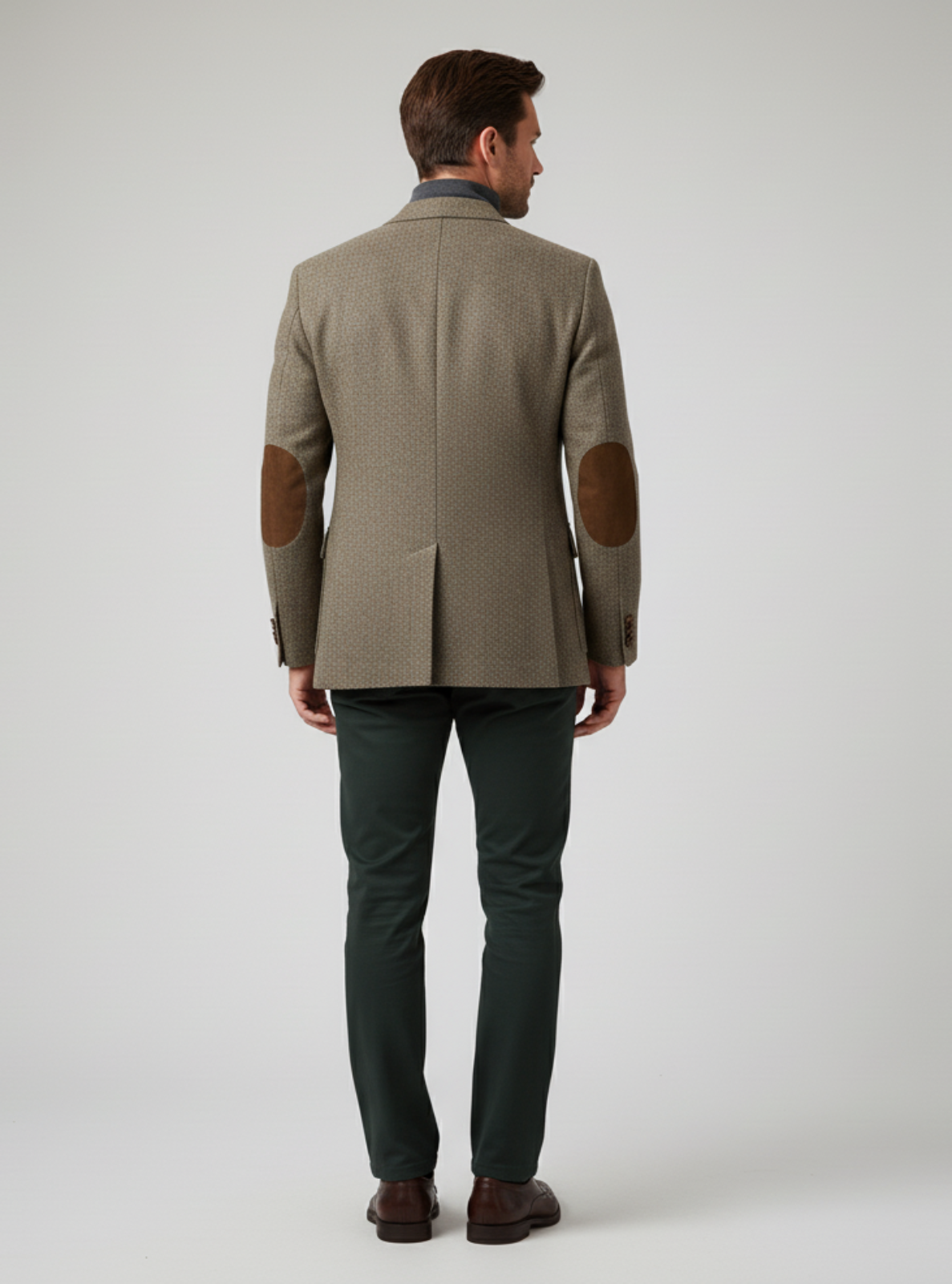 Man wearing a brown jacket with elbow patches on a white background