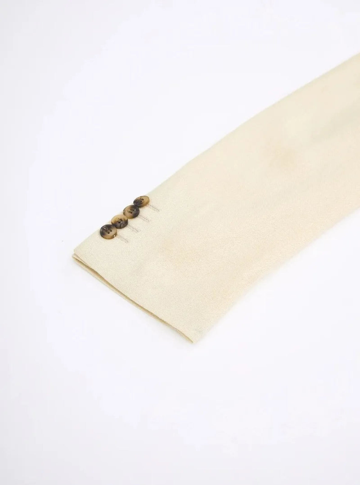 Beige fabric with buttons on a white background