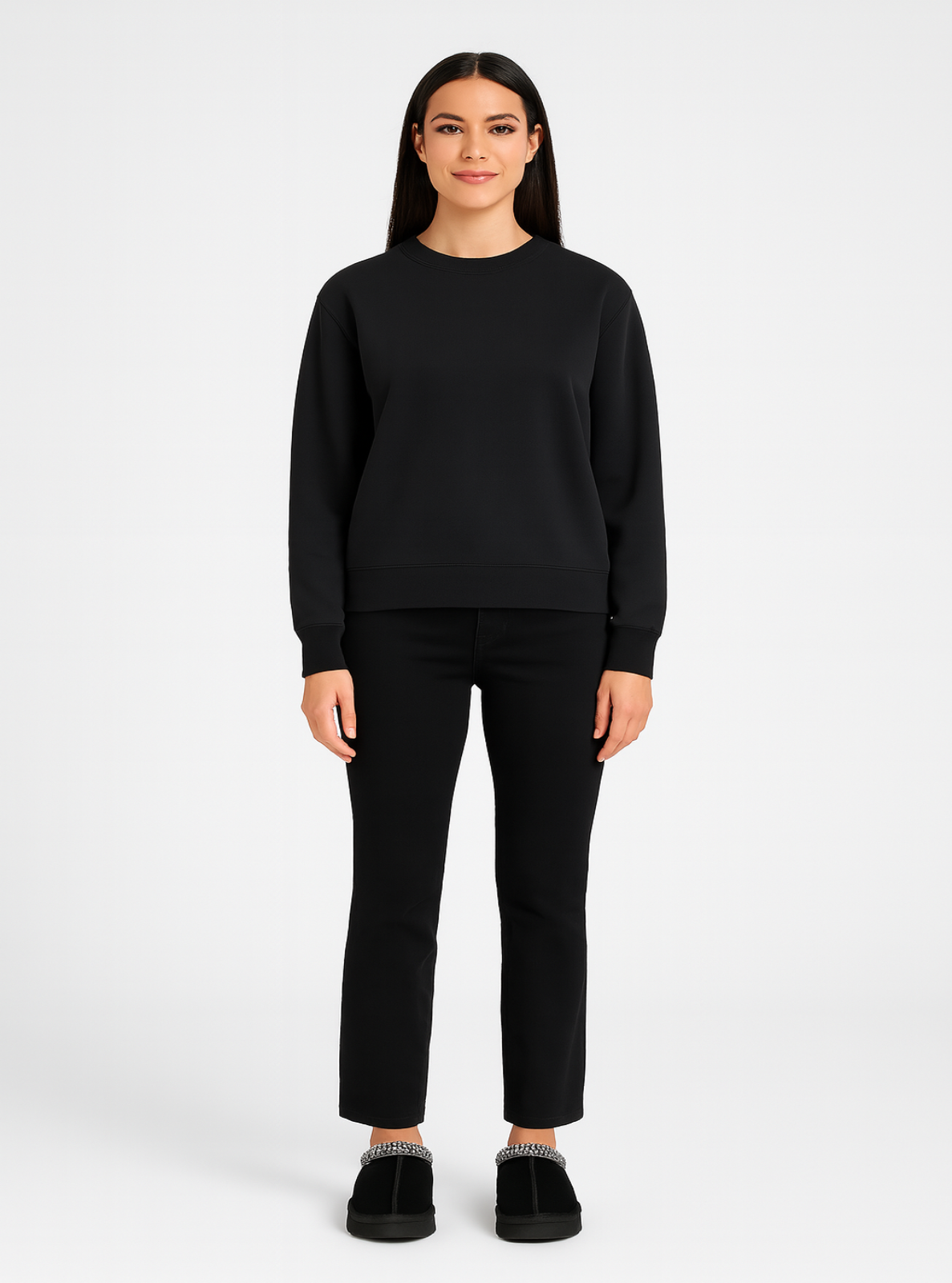 Person wearing a black sweater and pants on a white background