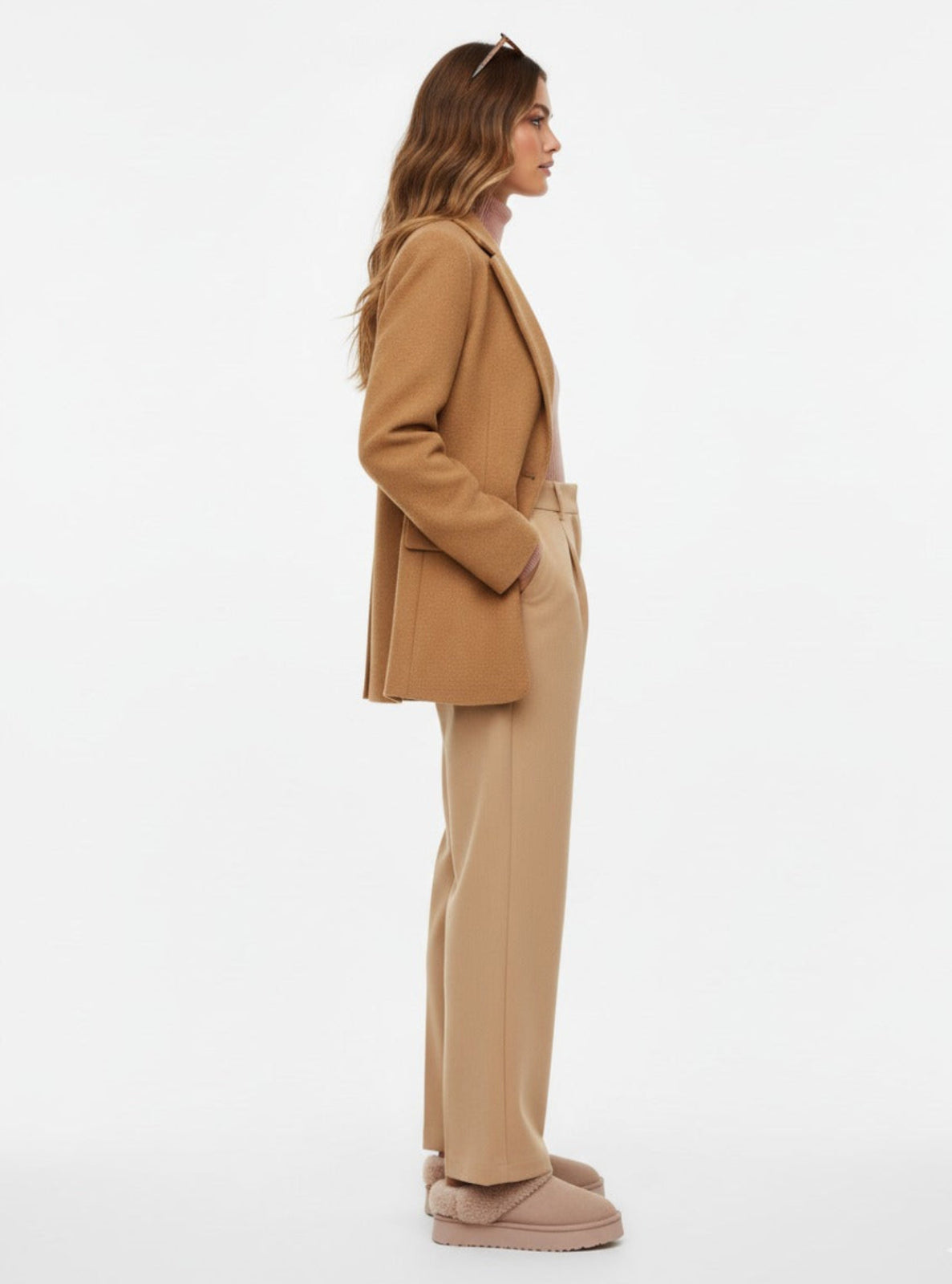 Woman wearing a beige suit on a white background