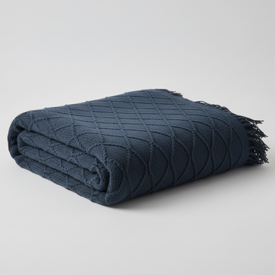 Folded navy blue blanket on a light gray background
