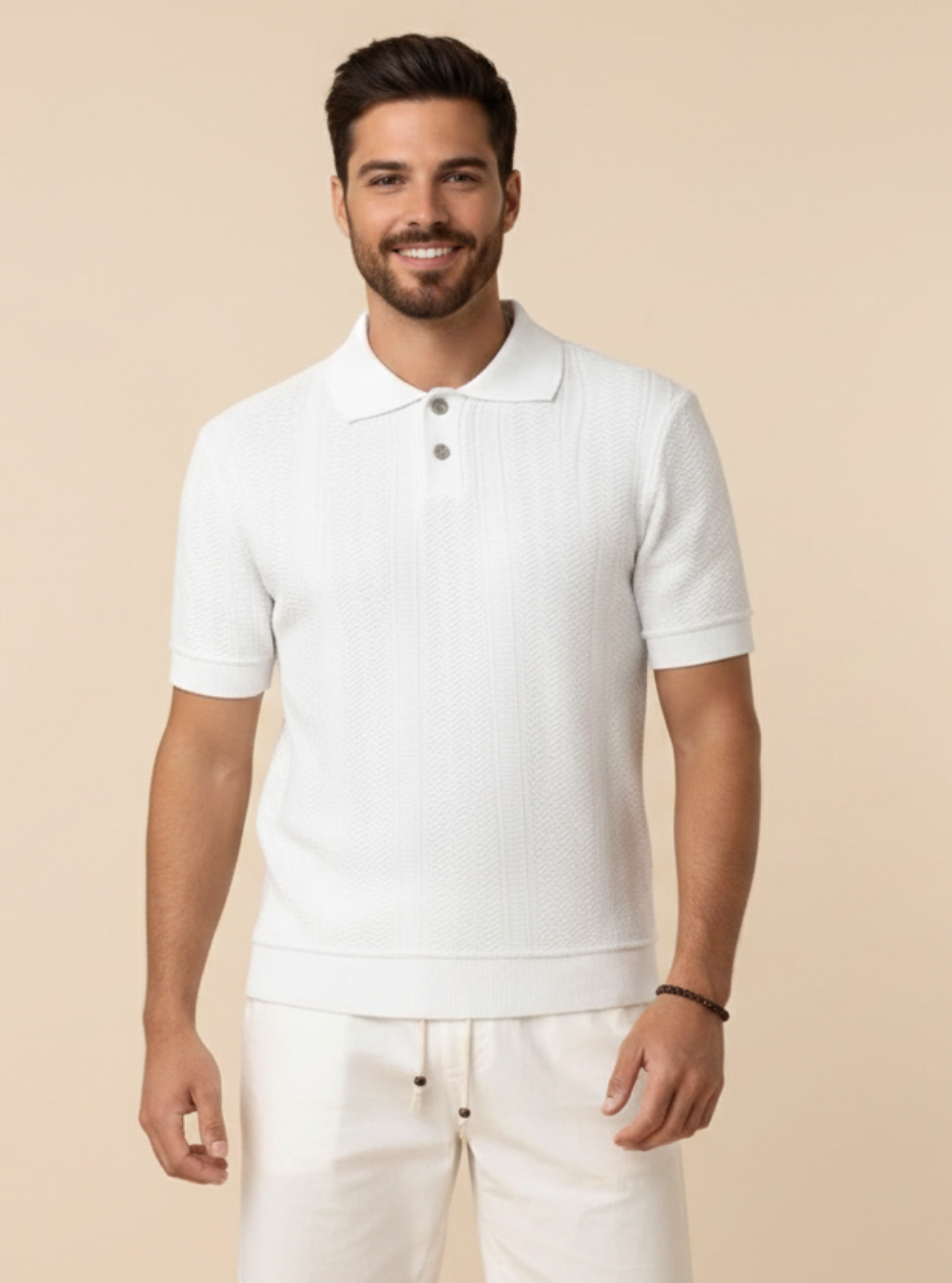 Man wearing a white polo shirt and pants against a beige background