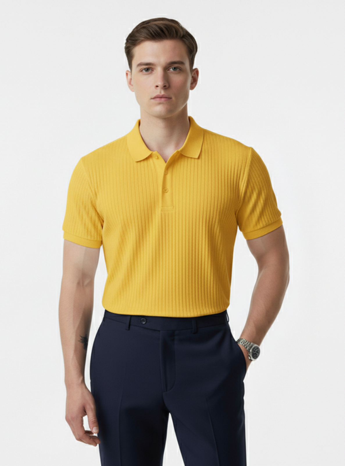 Man wearing a yellow polo shirt and navy pants on a white background