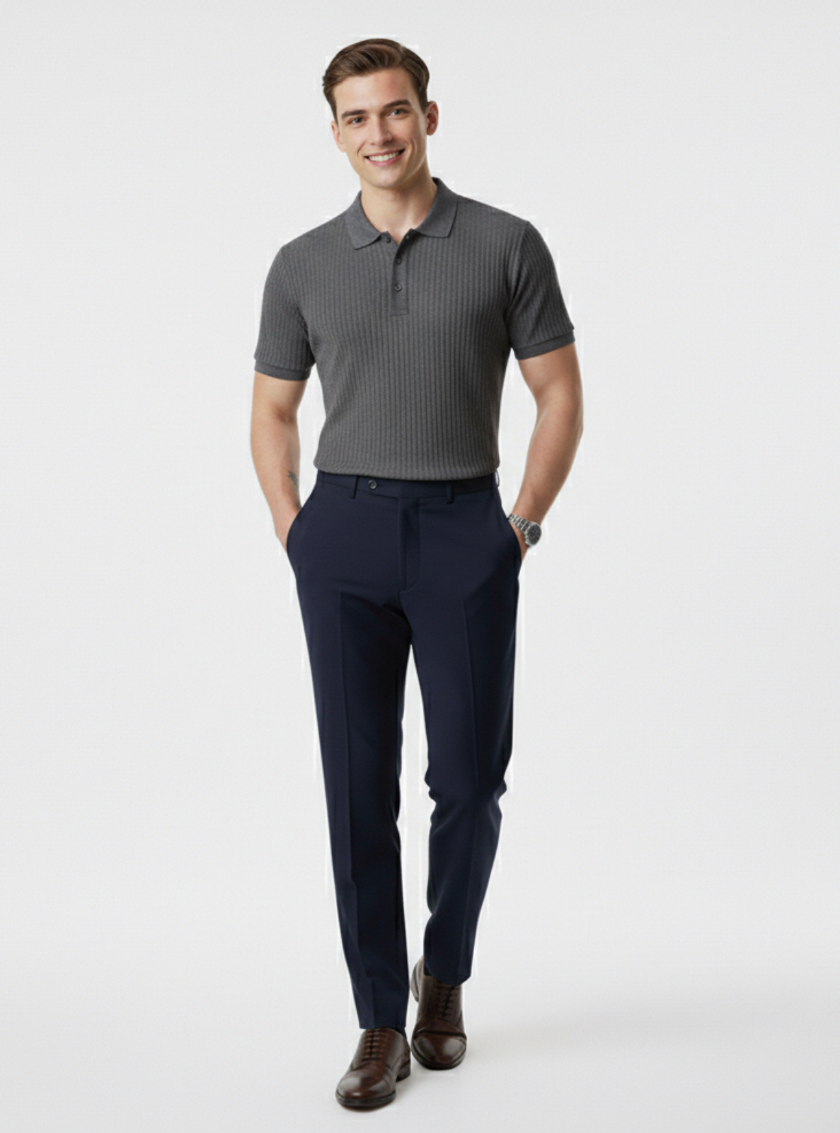 Man wearing a gray polo shirt and navy pants on a white background