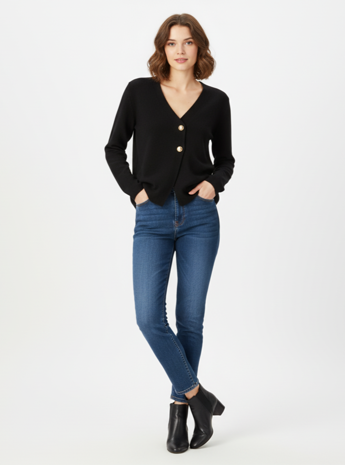 Woman wearing a black cardigan and blue jeans on a white background