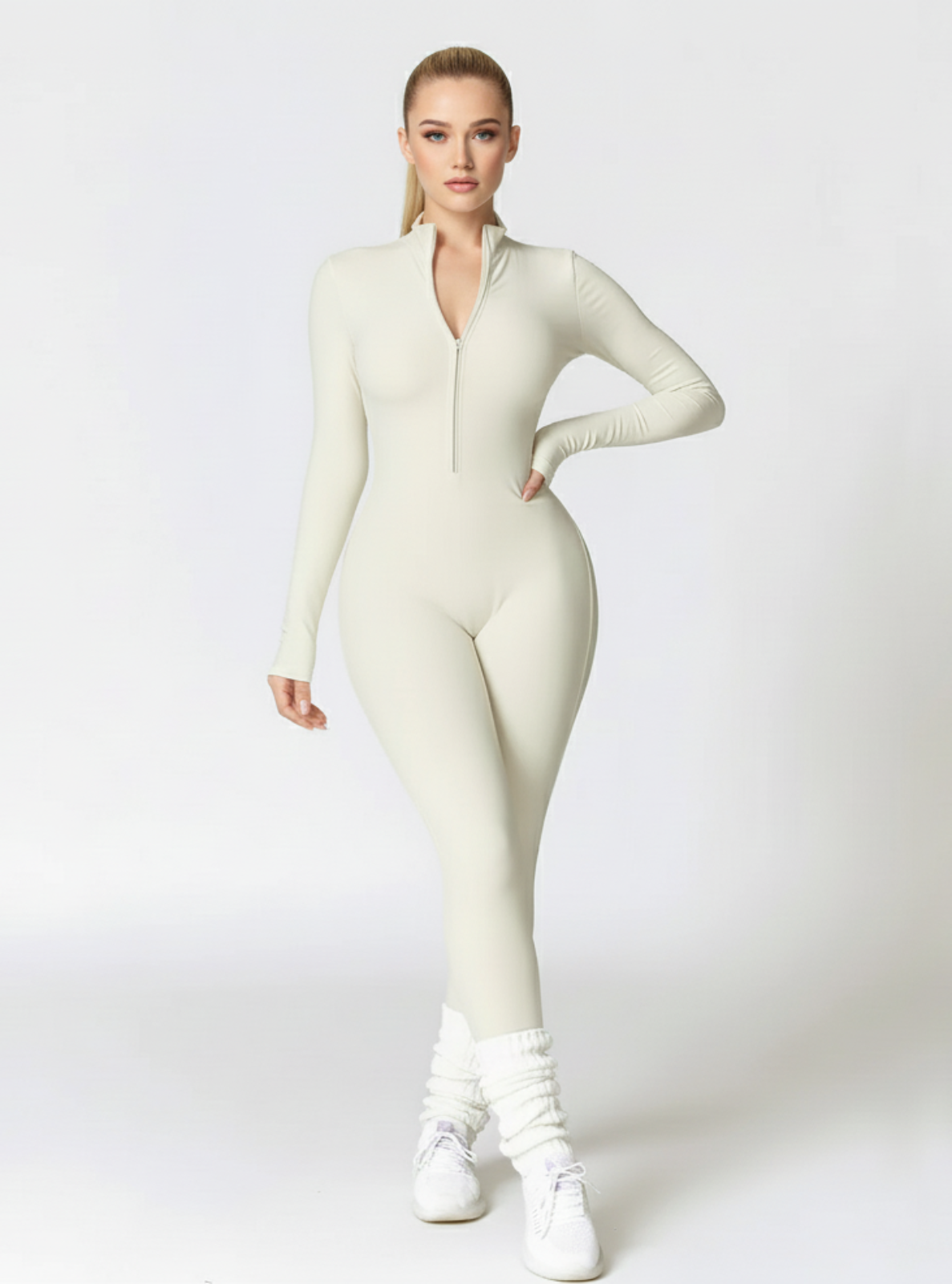 Woman wearing a white bodysuit on a light gray background