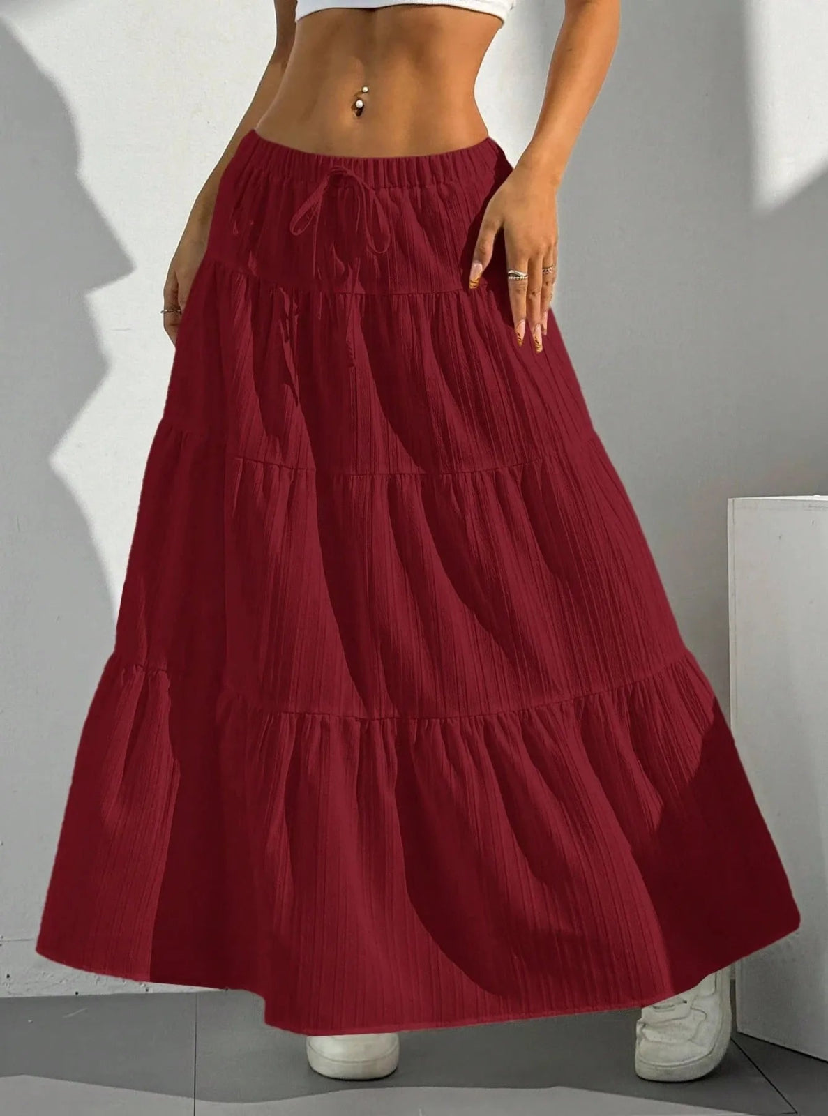 Red tiered skirt worn by a person on a plain background