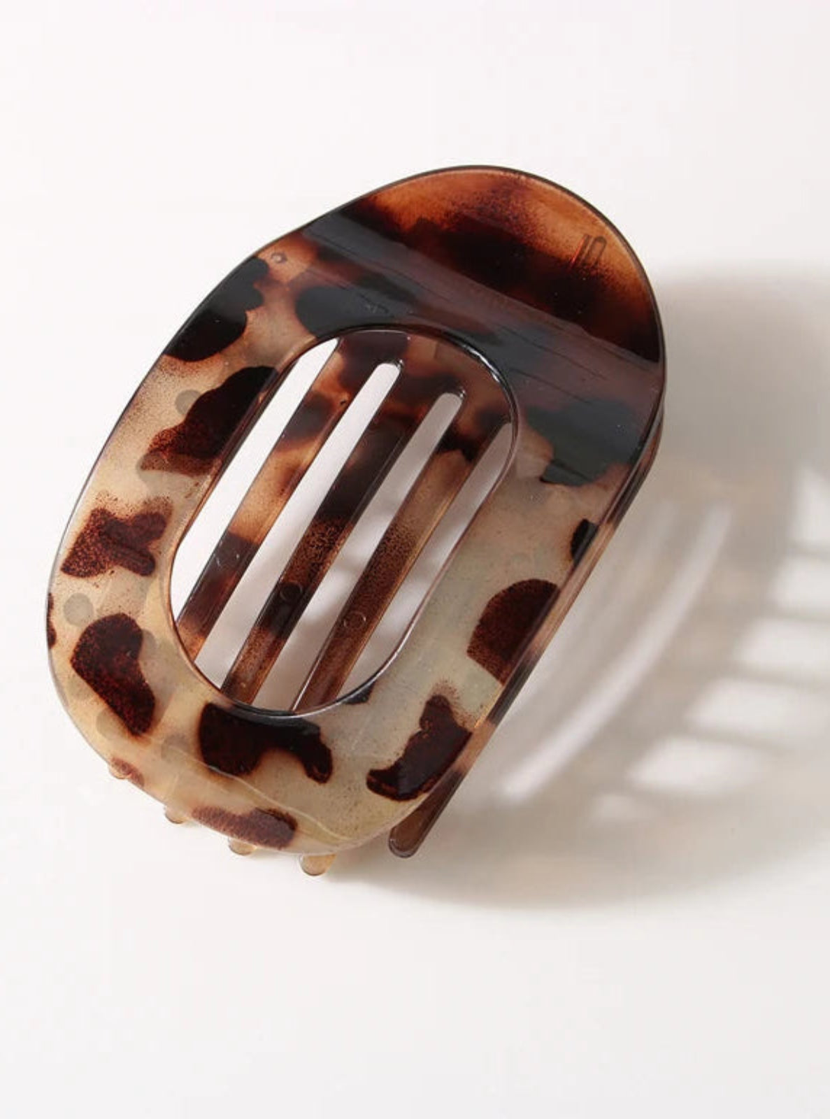 Tortoiseshell patterned hair clip on a white background