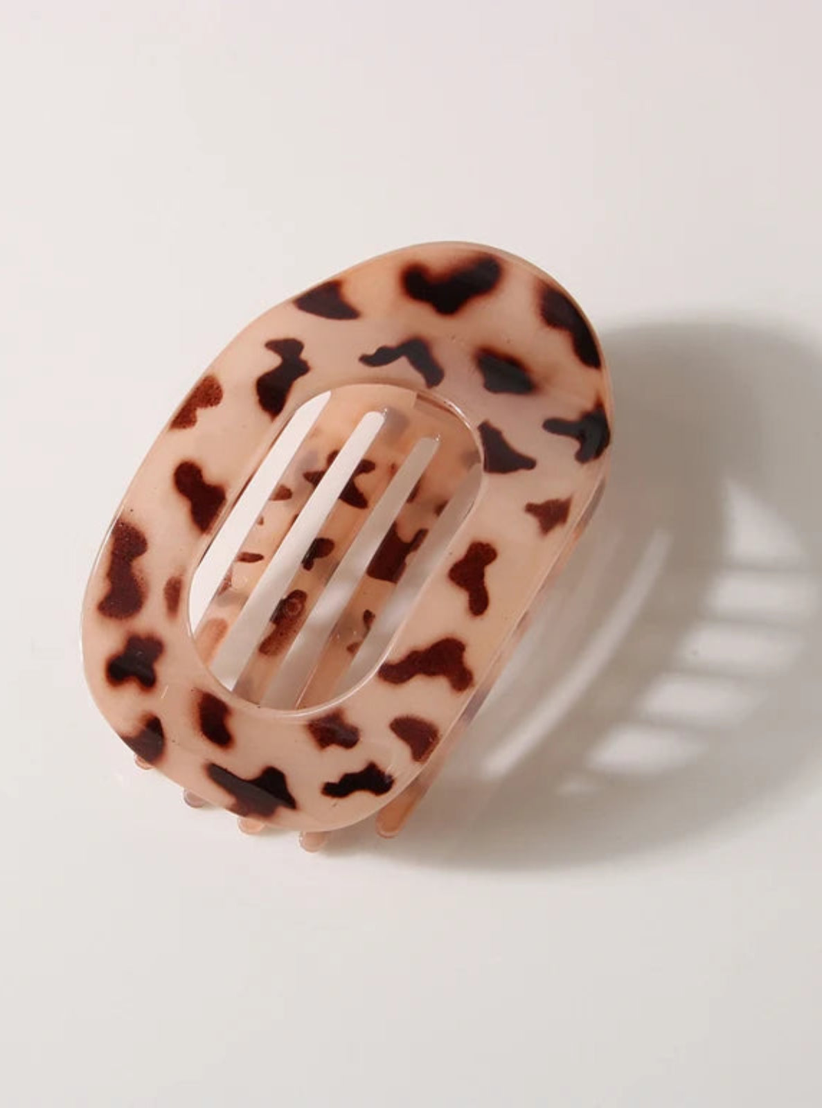 Leopard print hair clip on a light background
