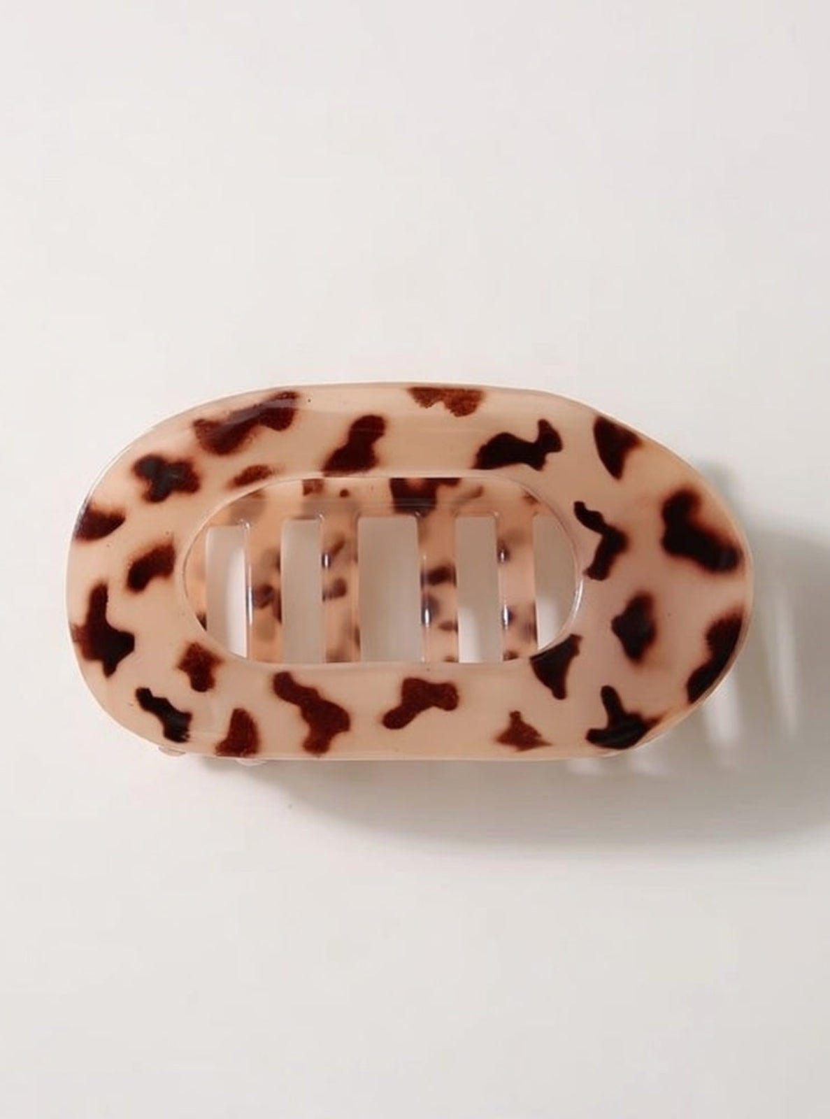 Leopard print hair clip on a white background