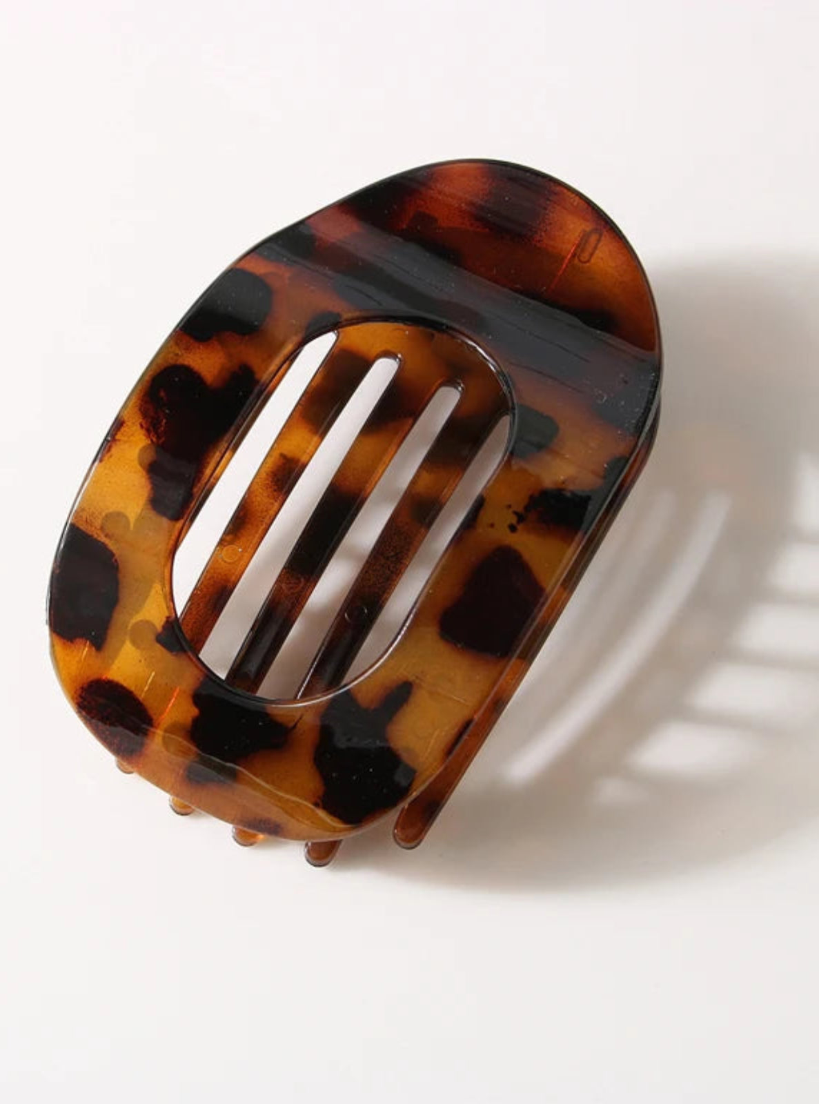 Tortoiseshell patterned hair clip on a white background