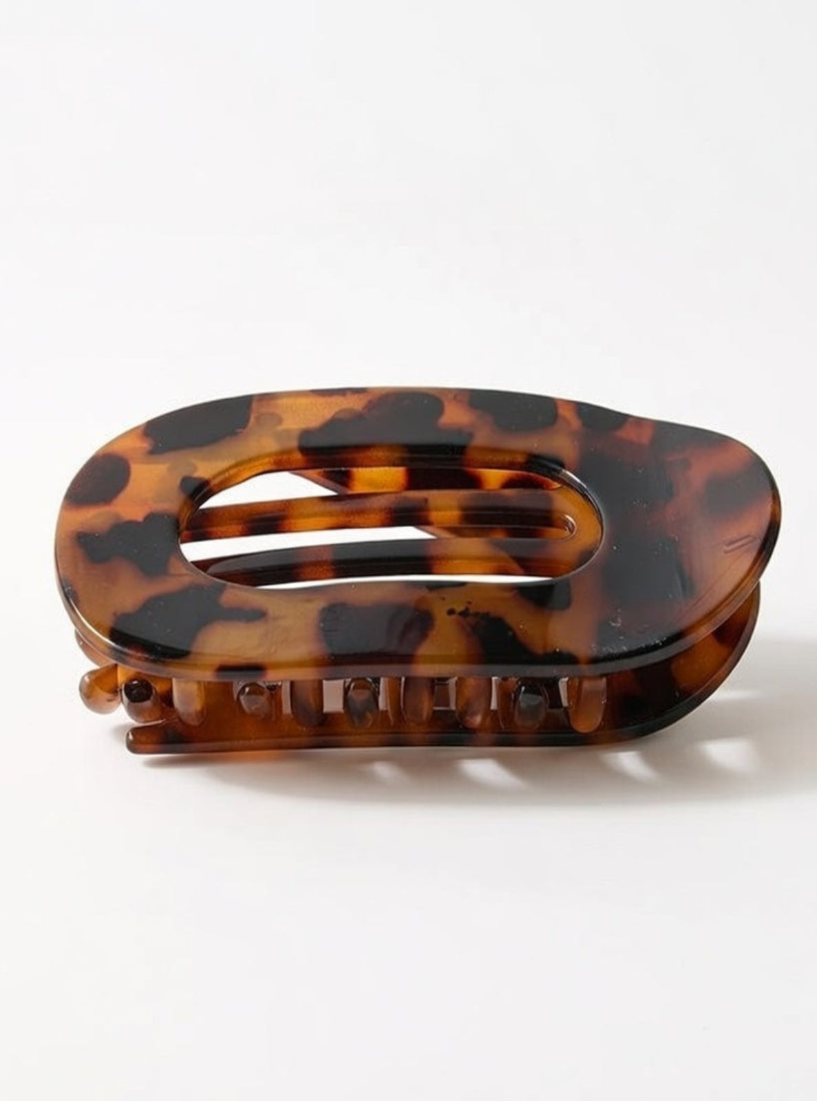 Tortoiseshell patterned hair clip on a white background