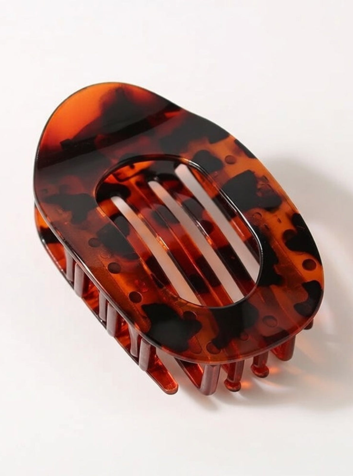 Tortoiseshell patterned hair clip on a white background