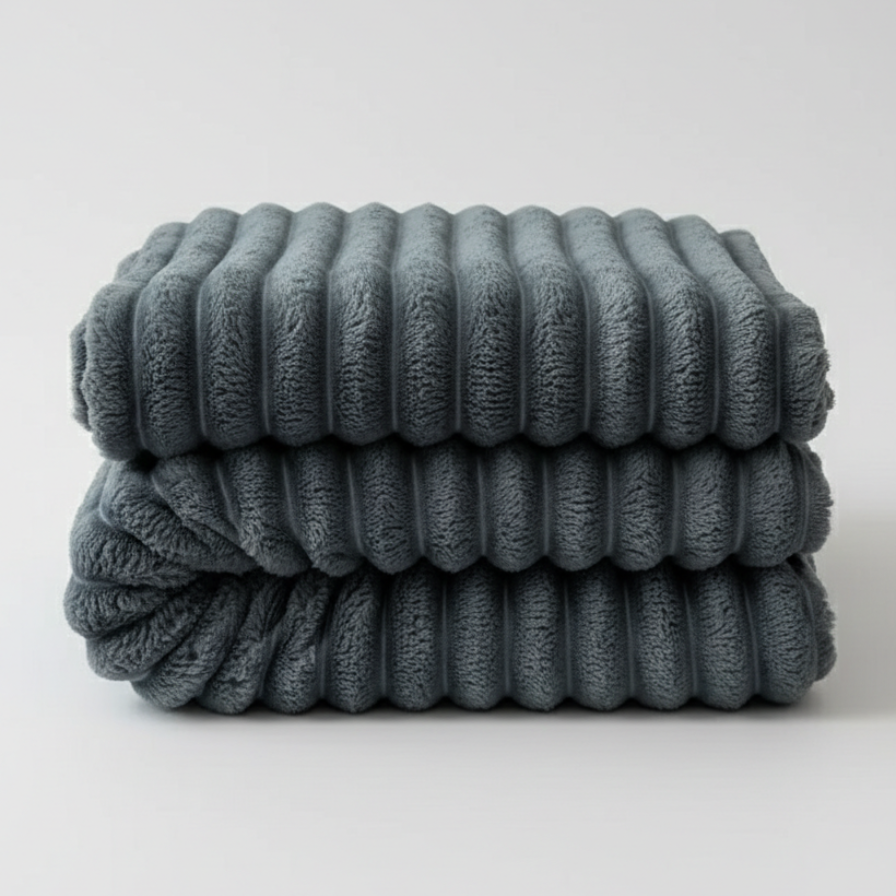 Stack of folded ribbed towels on a light gray background