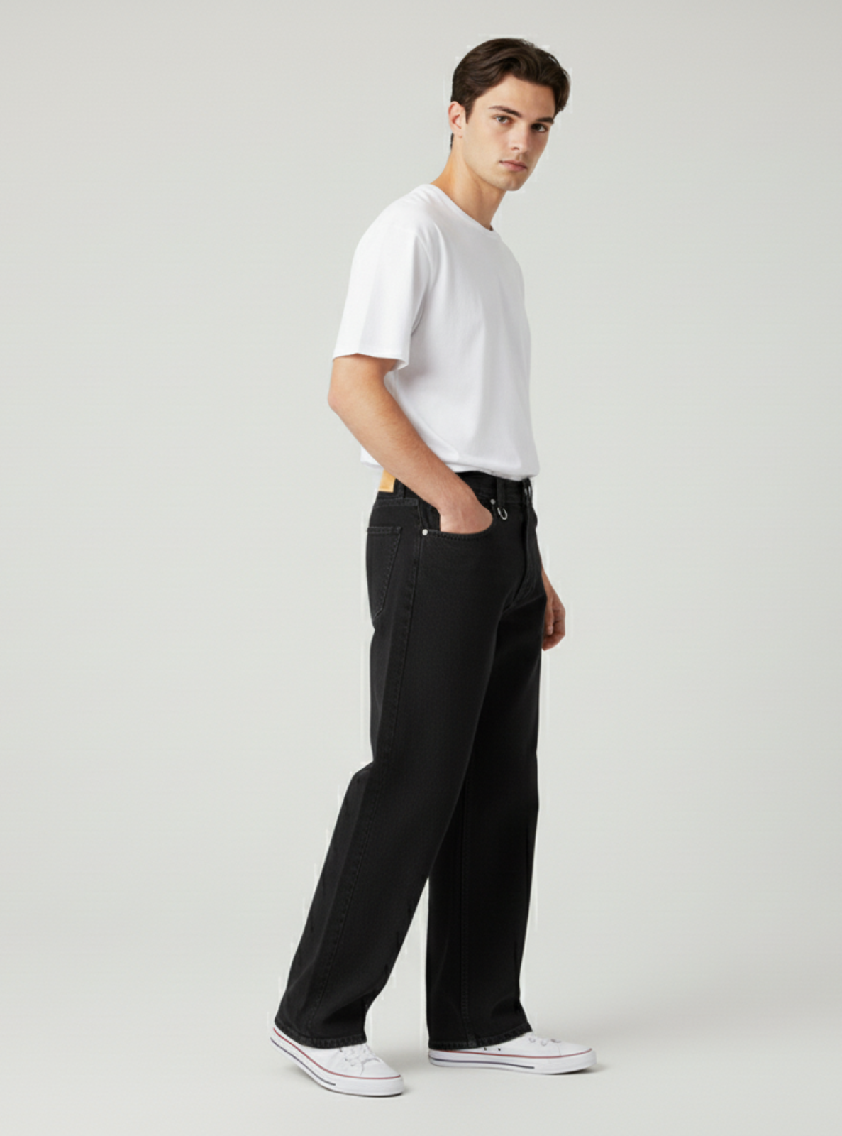 Person wearing a white t-shirt and black pants on a plain background